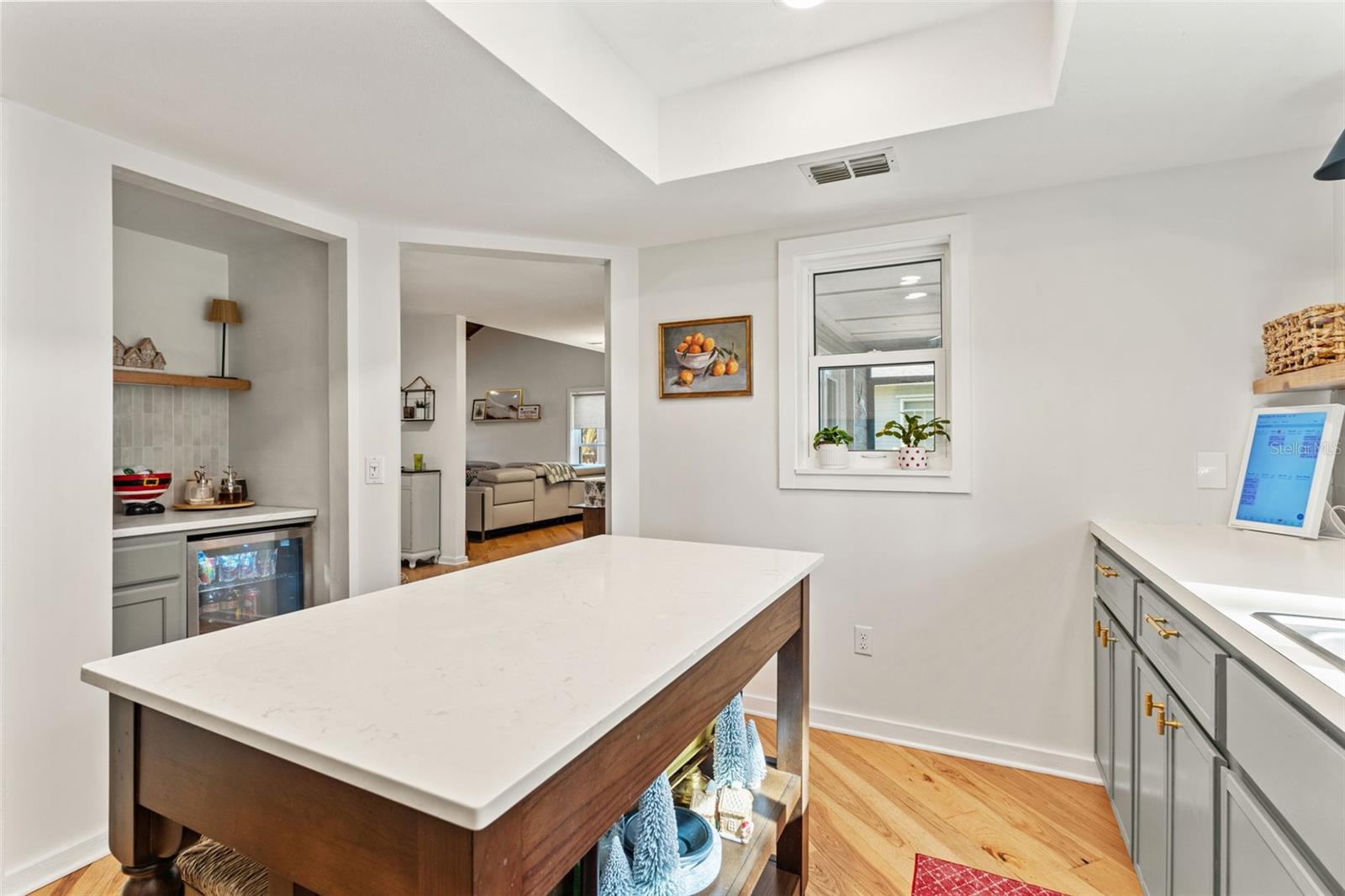 Built-in beverage nook with counter space, storage, and beverage refrigerator—ideal for entertaining.