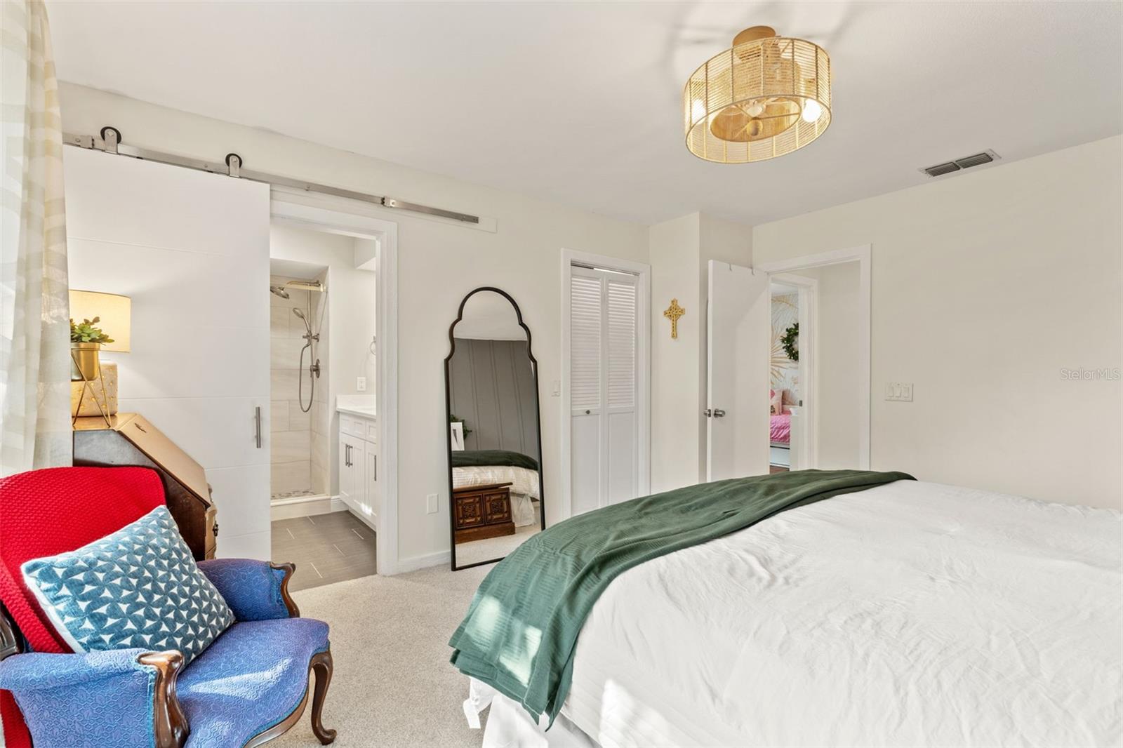 Primary bedroom with direct access to the renovated ensuite bathroom and nearby closet.