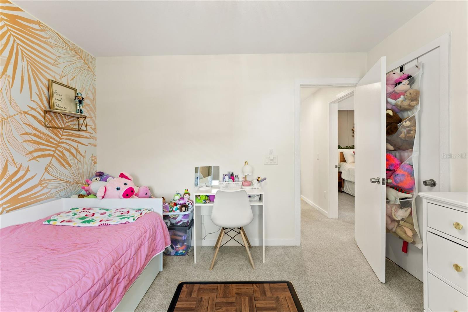 Versatile bedroom with space for a desk or play area, plus direct hallway access.