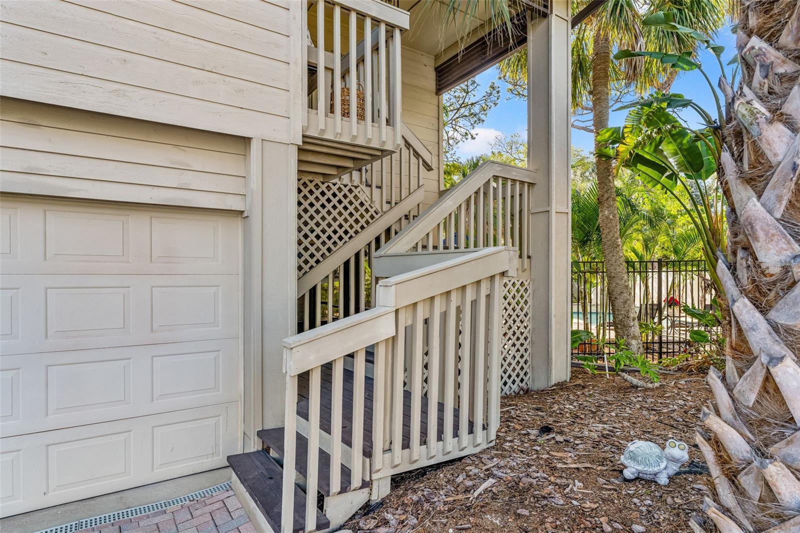 Oversized two-car garage with exterior stair access to the main living level, accented by covered landings.