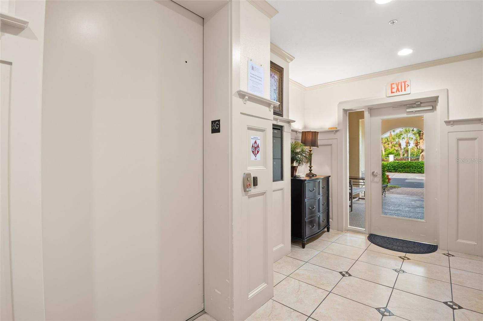 Entering into the building lobby with access to the elevator.