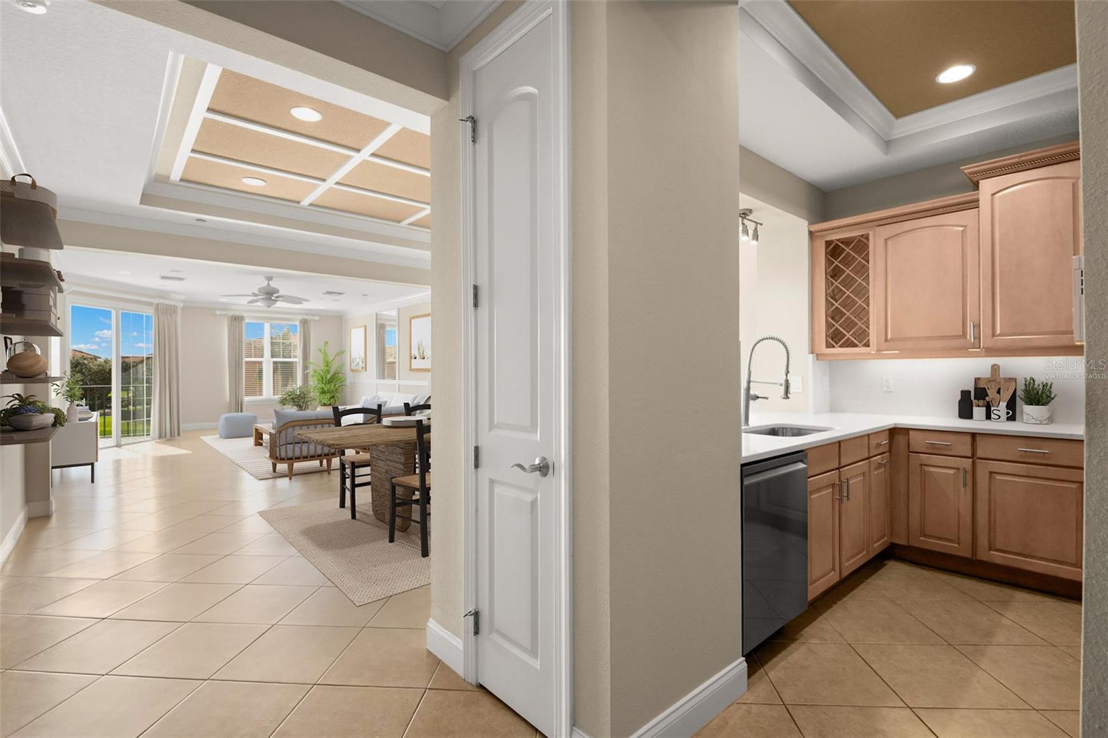 Virtually staged; approaching Kitchen with Dining Room, Living Room and covered Terrace access.