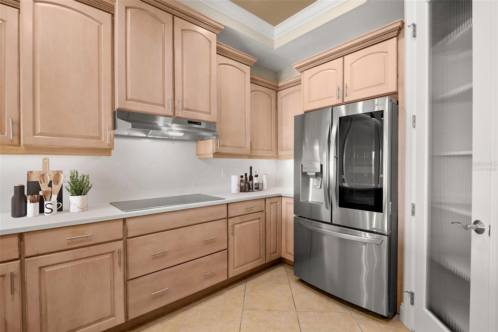Virtually staged; partial view of the Kitchen featuring extensive counter space.