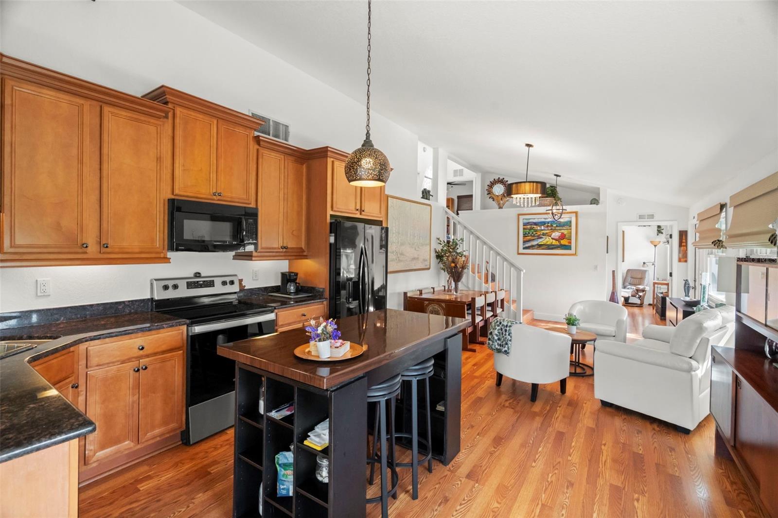 The living and dining areas blend seamlessly into the kitchen creating a space that feels both inviting and elegant.