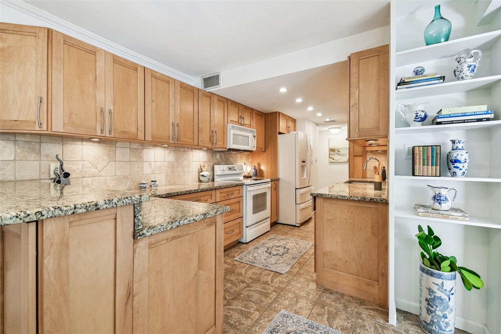 updated wood cabinetry, granite and upgraded appliance