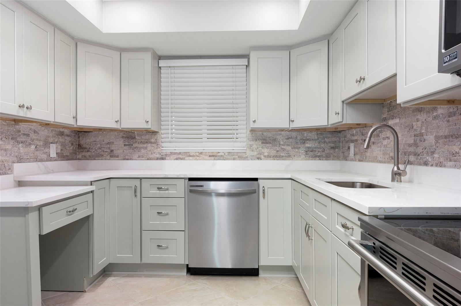 BRAND NEW Kitchen. All New Cabinets, includes a small desk area, brand new appliances, quartz counters and backsplash.