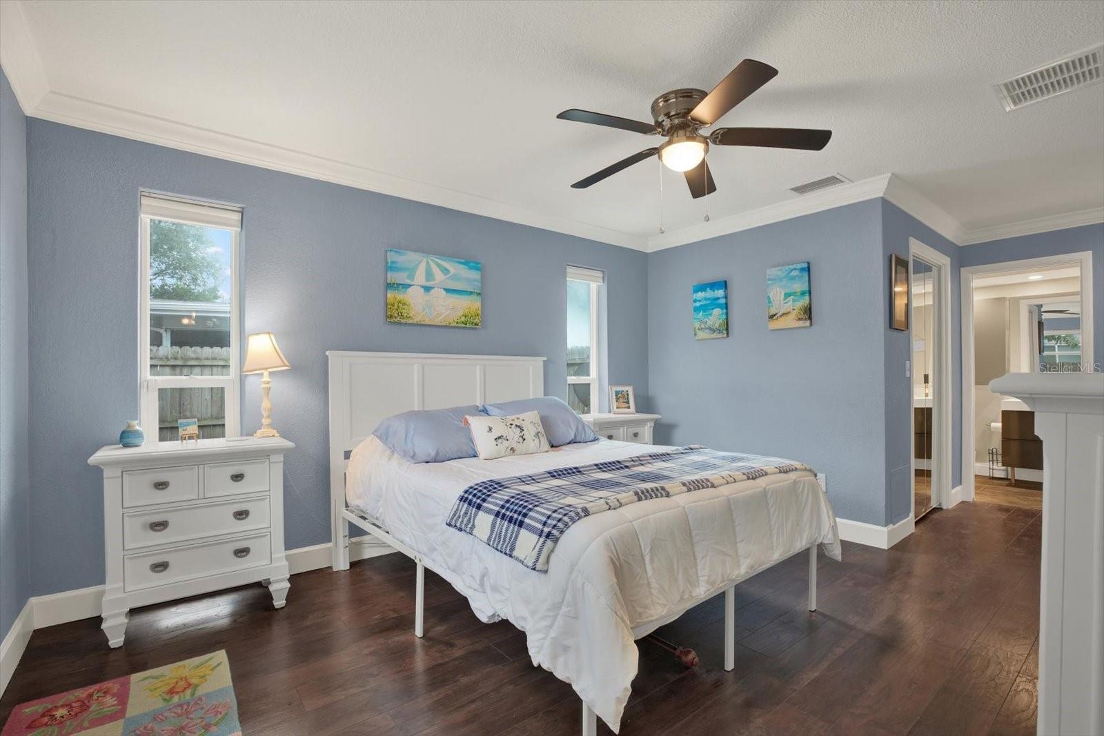 Lovely light floods the large primary bedroom