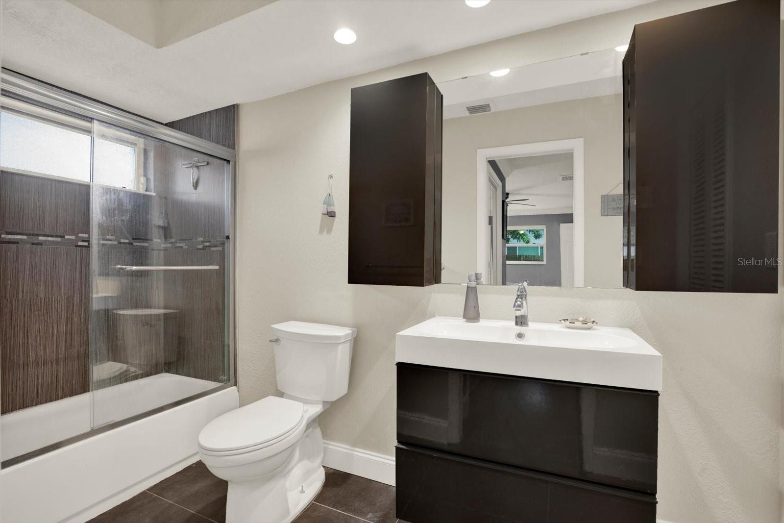 Updated primary bathroom has a large soaking tub/shower combo