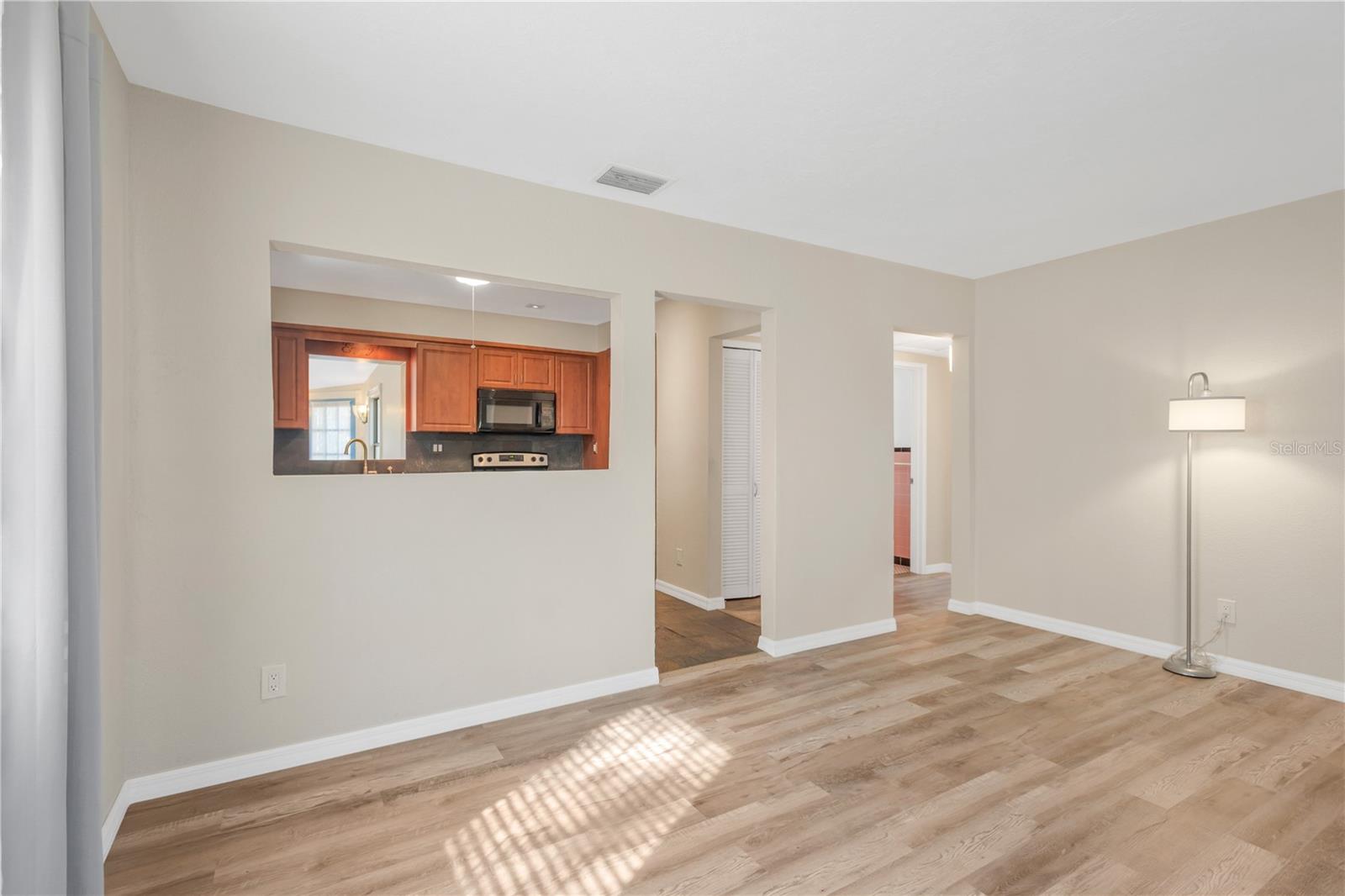 Living Room Looks Into Kitchen