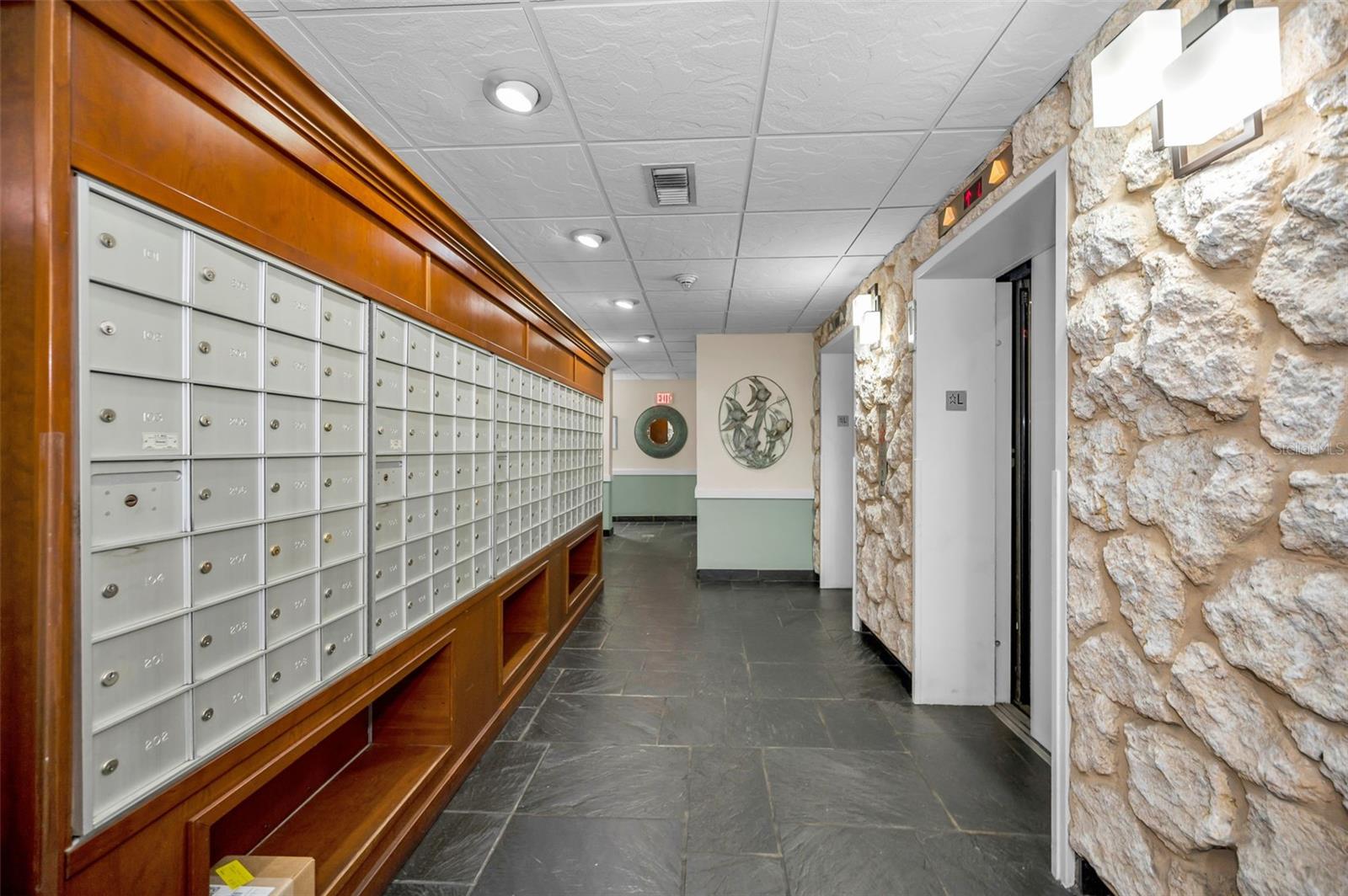 Mailboxes in main lobby across from elevators