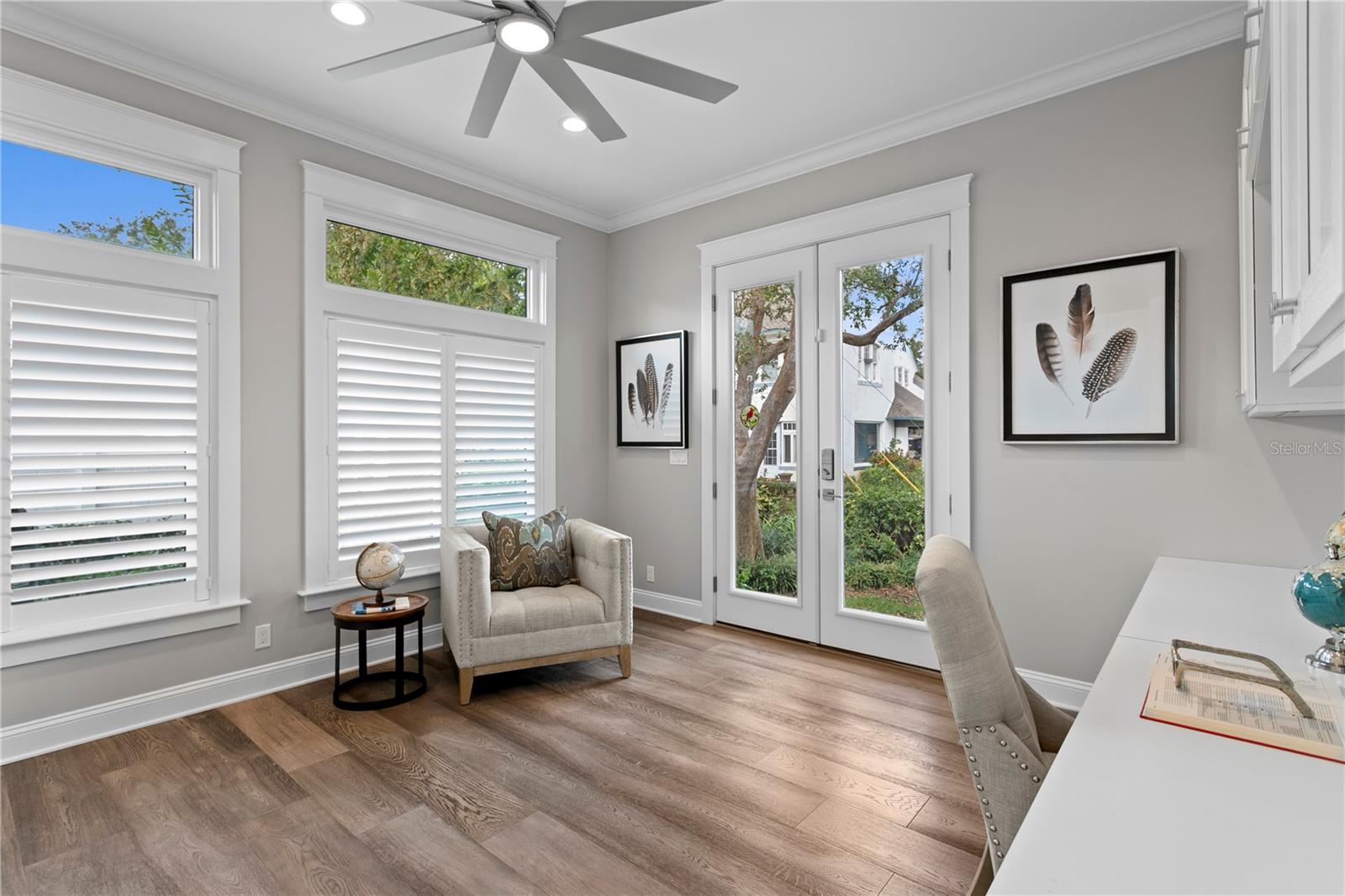Bedroom 3 currently being used as an office, yet flexible for any lifestyle.  Natural light abounds via transom windows and custom plantation shutters