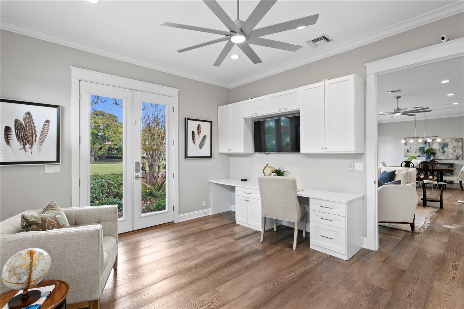 3rd bedroom with backyard access and built-in, custom cabinetry