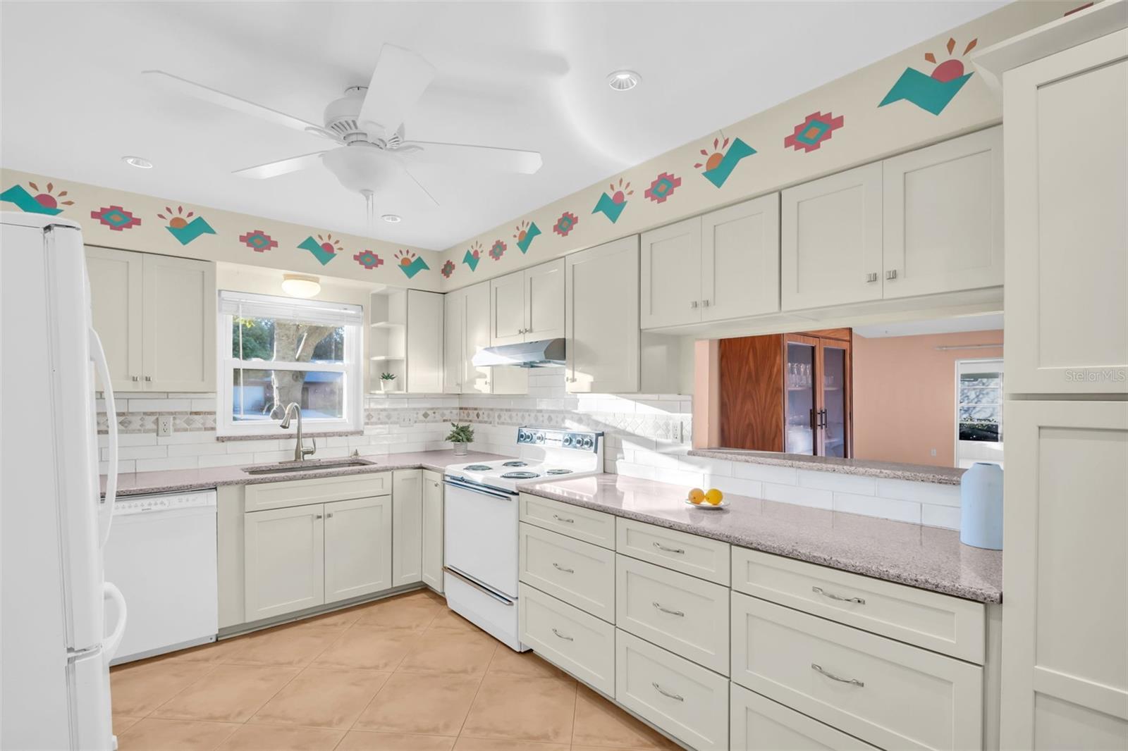 Updated kitchen with granite countertops in the heart of the home with convenient pass-through window to the dining/living room combo~