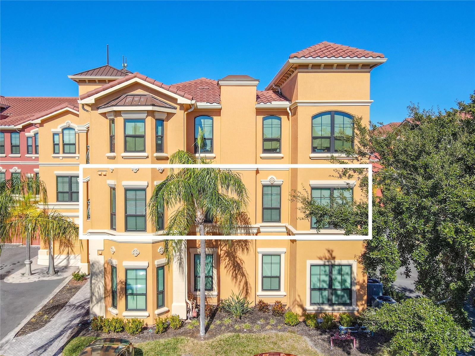 Sun-drenched Mediterranean elegance rises above palm-lined grounds, welcoming you to refined waterfront living at The Grand Bellagio.