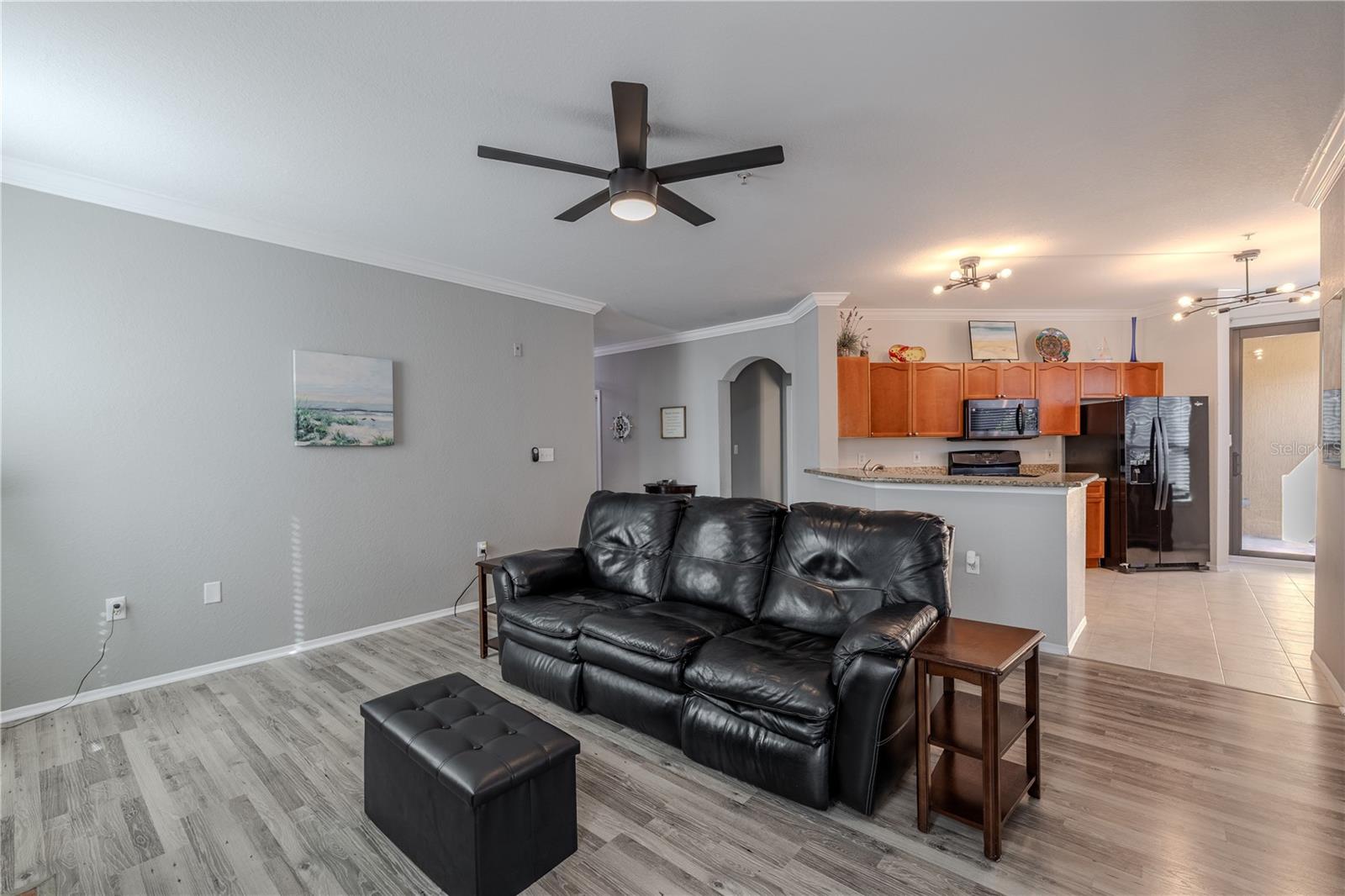 This bright corner den features wraparound windows, crown molding, and flexible space ideal for a home office, study, or guest room, filled with natural light throughout the day.