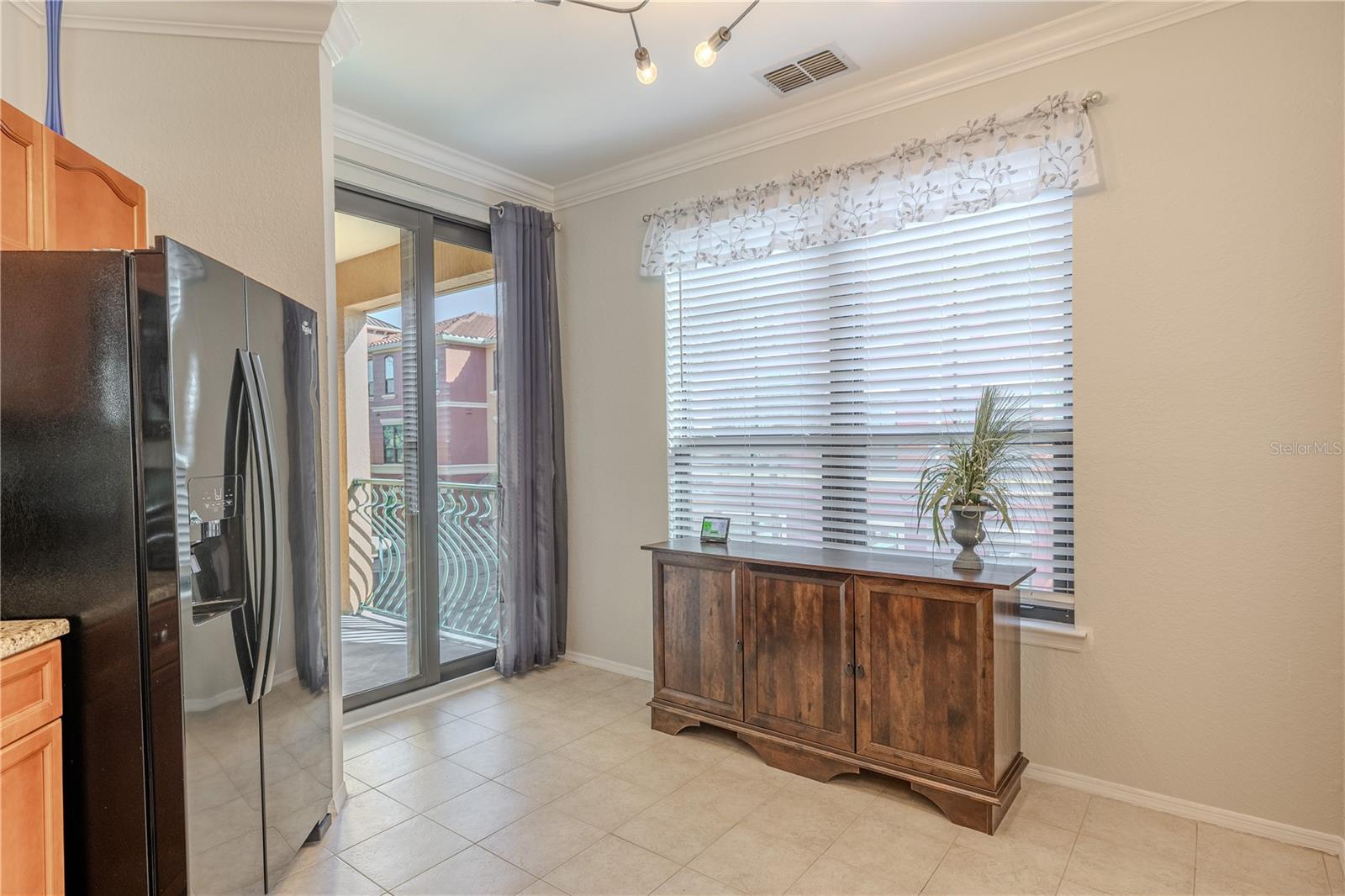 A private covered balcony offers peaceful views of palm-lined courtyards and Mediterranean architecture, creating the perfect spot to enjoy morning coffee or evening breezes.