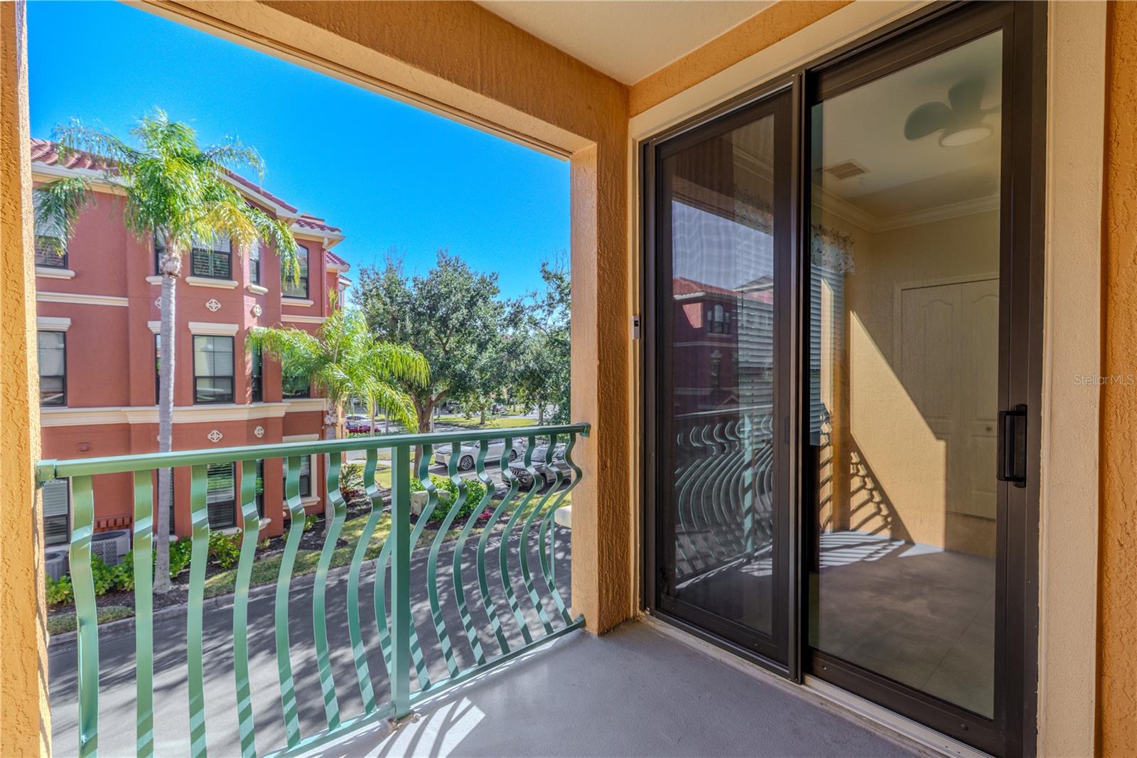 From the kitchen, the expansive granite counter overlooks the living and dining areas, highlighting the open layout, abundant natural light, and a cozy living room centered around a fireplace and modern ceiling fan.