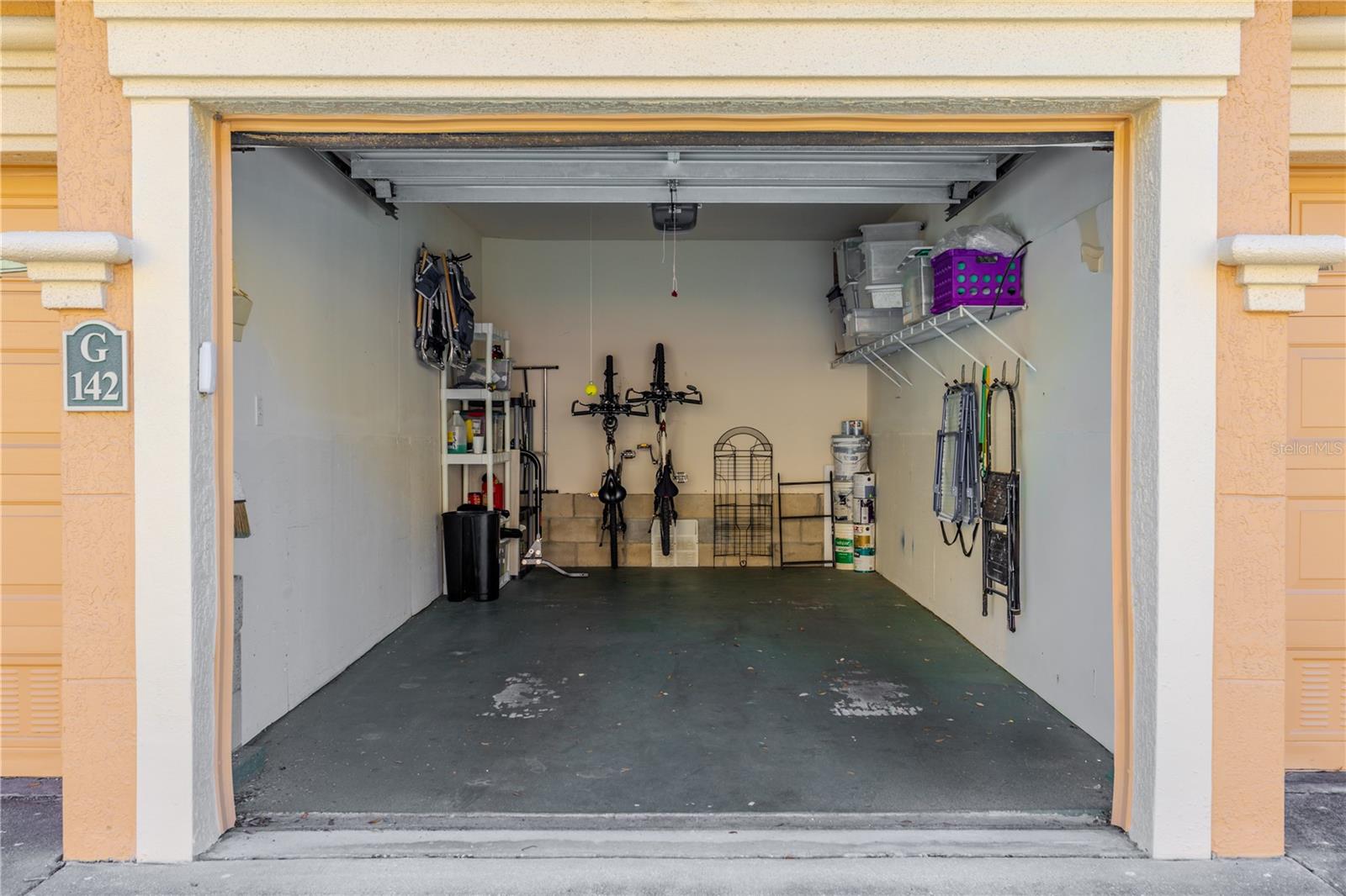 A sweeping aerial perspective captures the Grand Bellagio’s elegant Mediterranean architecture, palm-lined streets, and shimmering bay views in the distance—setting the scene for refined waterfront living.