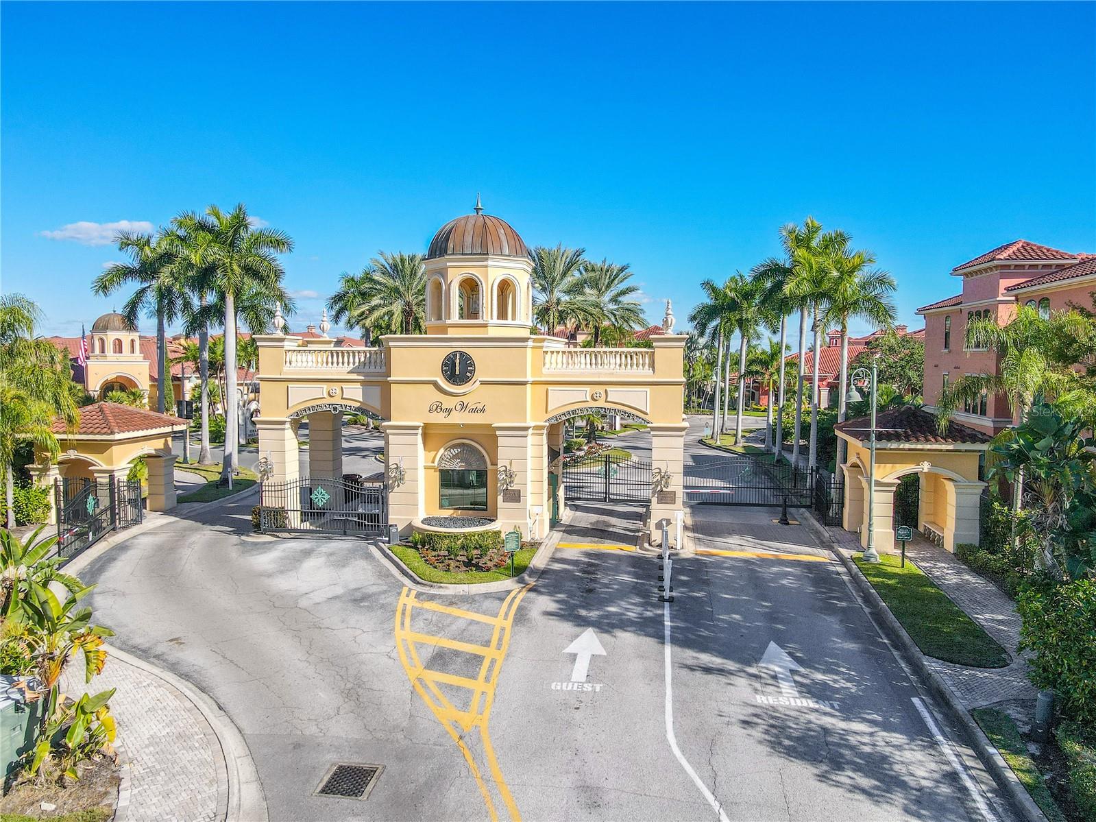 A resort-style community pool framed by palm trees, private cabanas, and expansive sun decks creates an inviting oasis for relaxation and social gatherings.