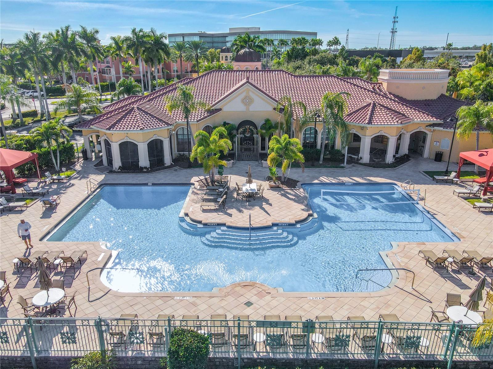 A breathtaking aerial showcases the community’s island-like setting, surrounded by calm waterways, private boat slips, and panoramic bay views stretching to the horizon.