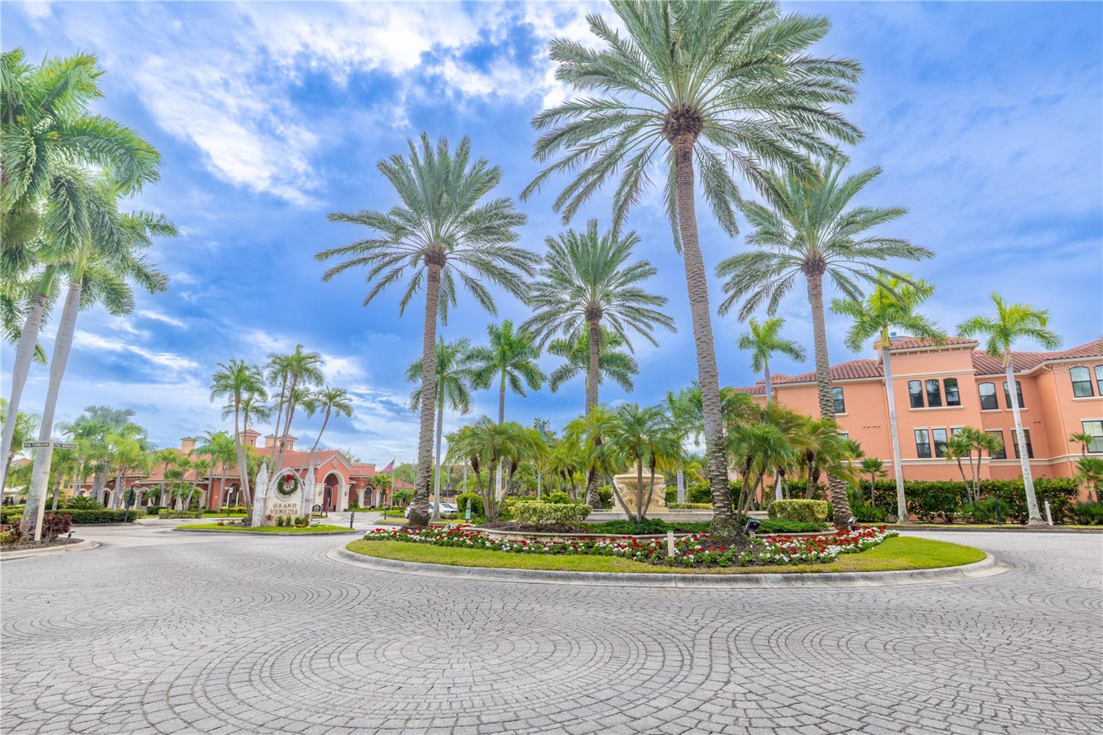 A coveted second-floor corner residence, bathed in natural light, sits gracefully within this palm-lined Mediterranean-style community.