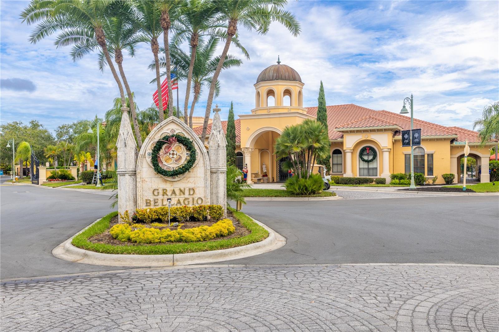 A bright, welcoming entry foyer features neutral tile flooring, crown molding, modern lighting, and a thoughtfully placed utility closet, creating a clean and polished first impression as you enter the residence.