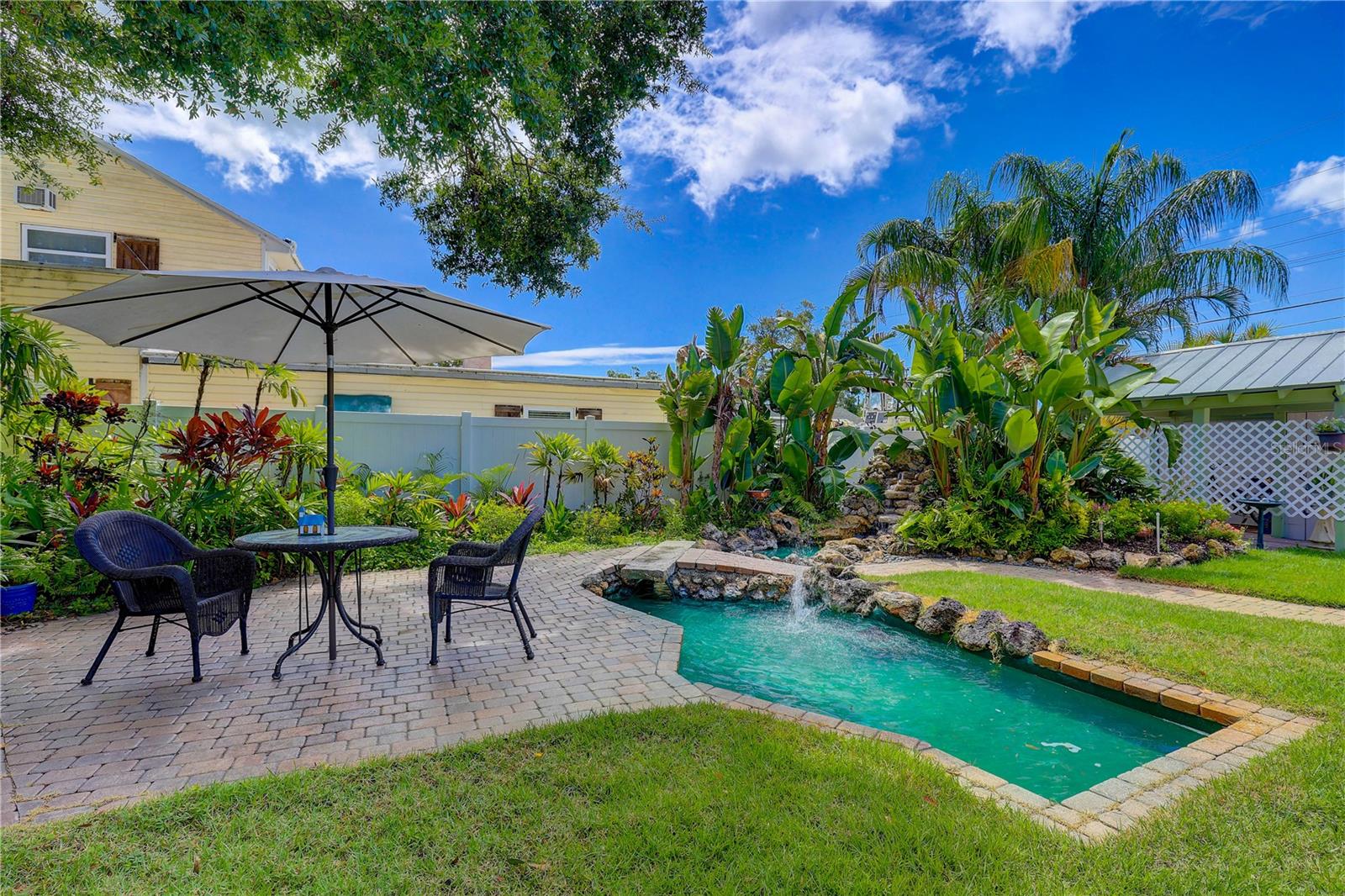 Sitting area by pond, see waterfall in back