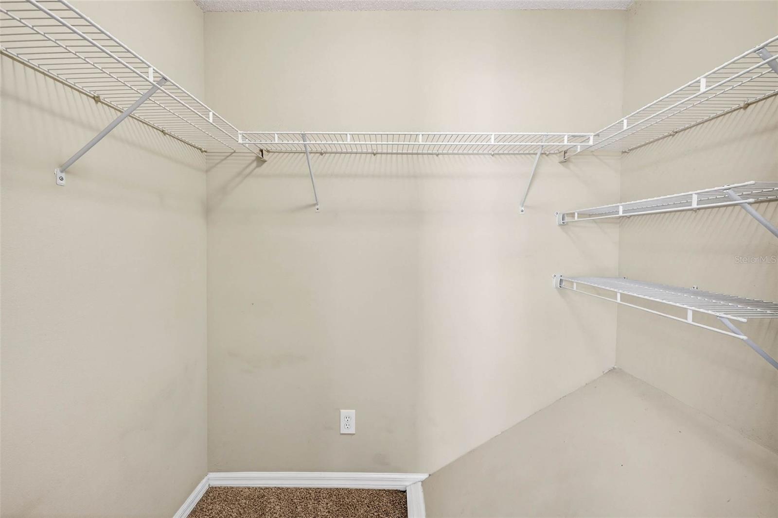 Primary bedroom walk-in closet