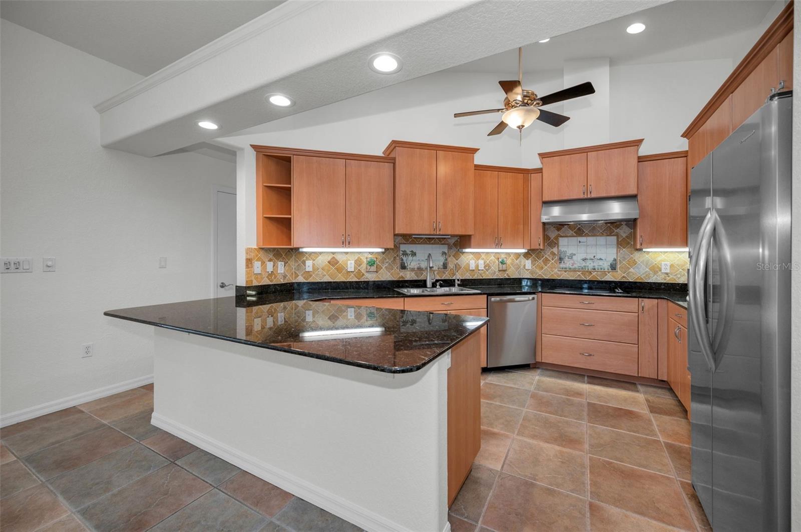 Your updated Kitchen looks over the Living Room and also has a lovey view of the screened pool and lanai.