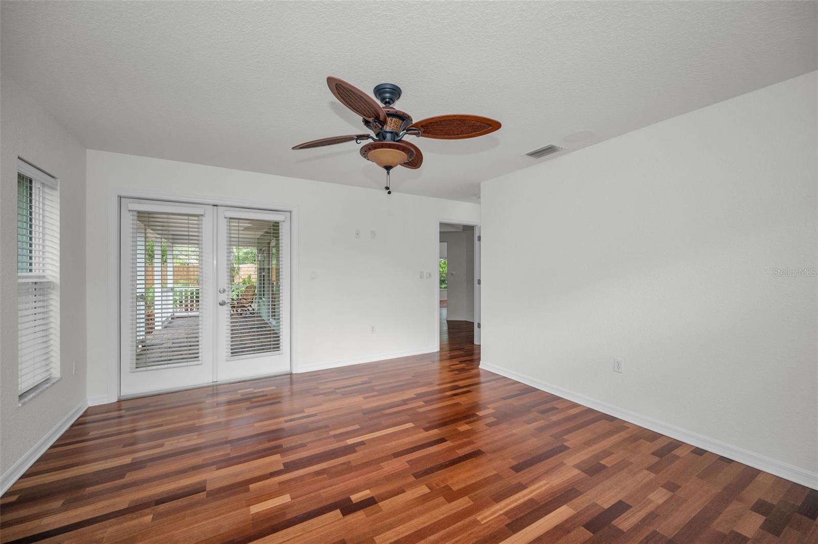 Primary Bedroom with En Suite Bathroom features French doors leading out to the front porch.