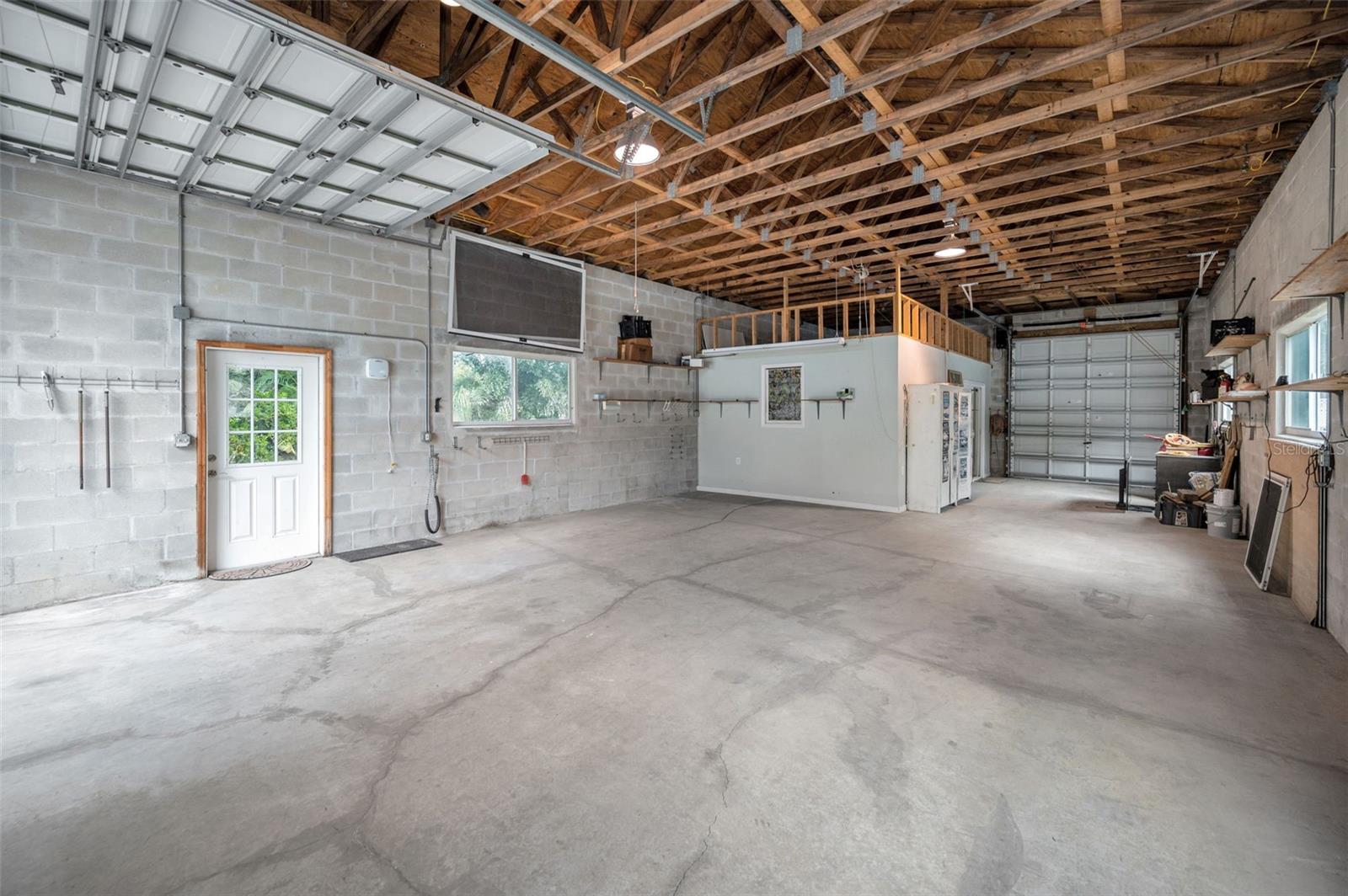 Inside the garage you will find a climate controlled privacy room ideal for an office, workout room, art studio, or creative space.
