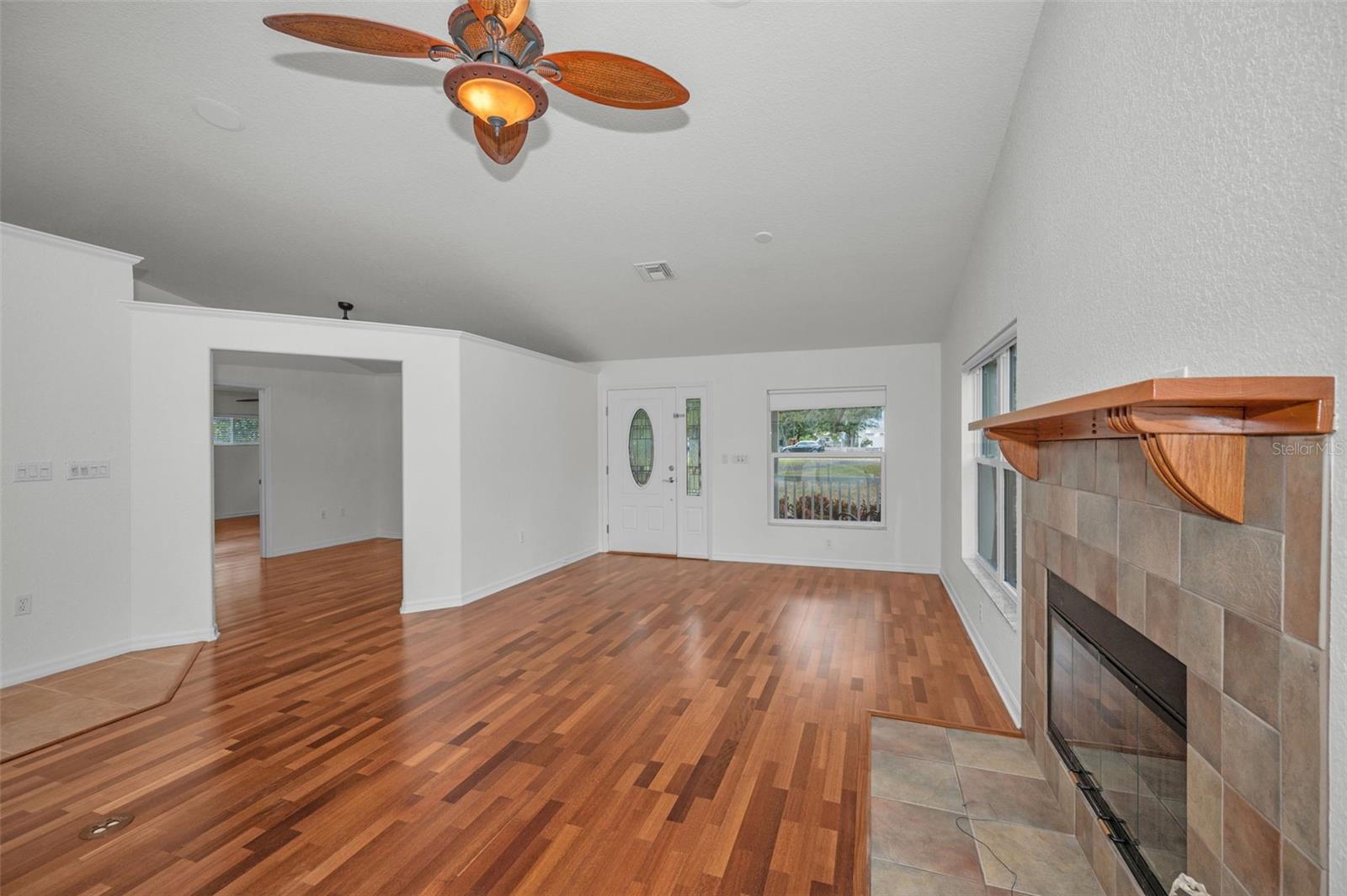 Upon entering you will notice high ceilings, an open floor plan with natural light, and a wood burning fireplace.