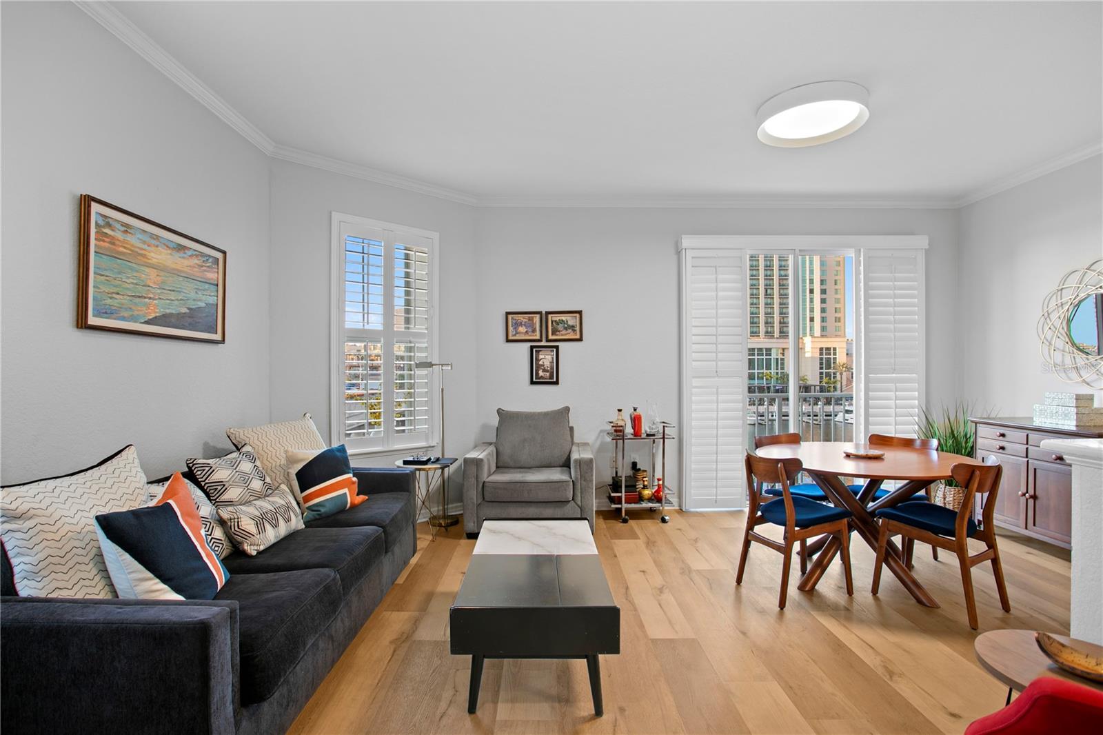 Bright, updated living room featuring an open layout with direct flow to the dining area and kitchen.