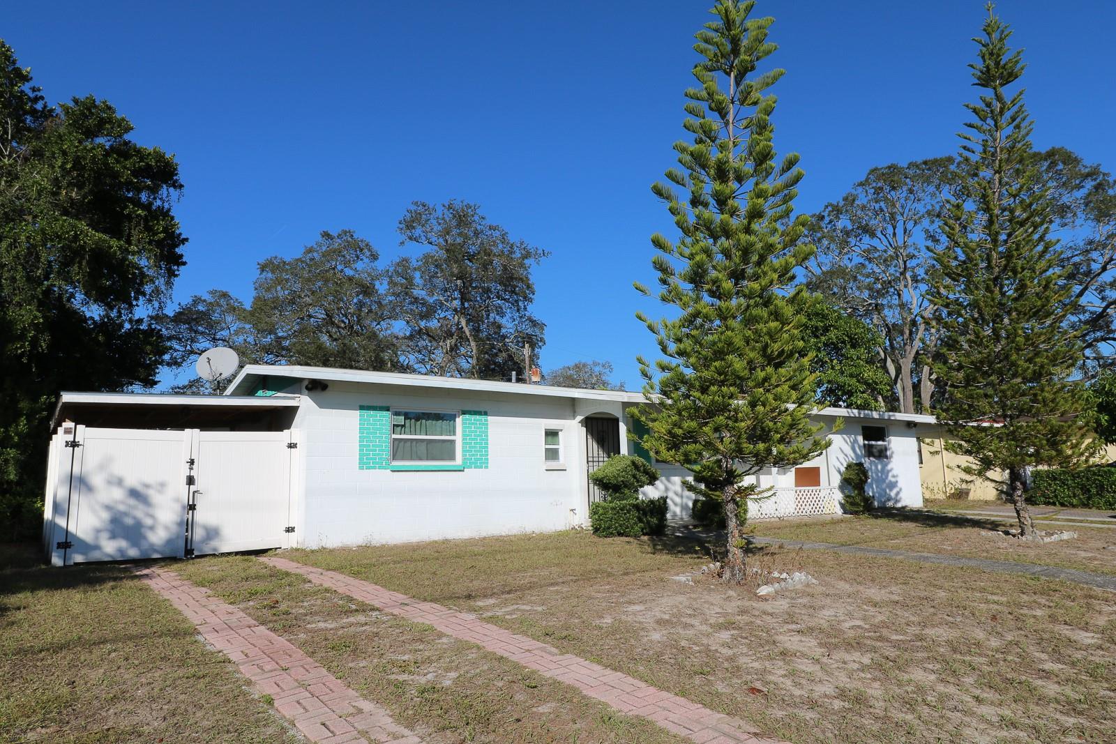Second driveway to a gated covered carport.