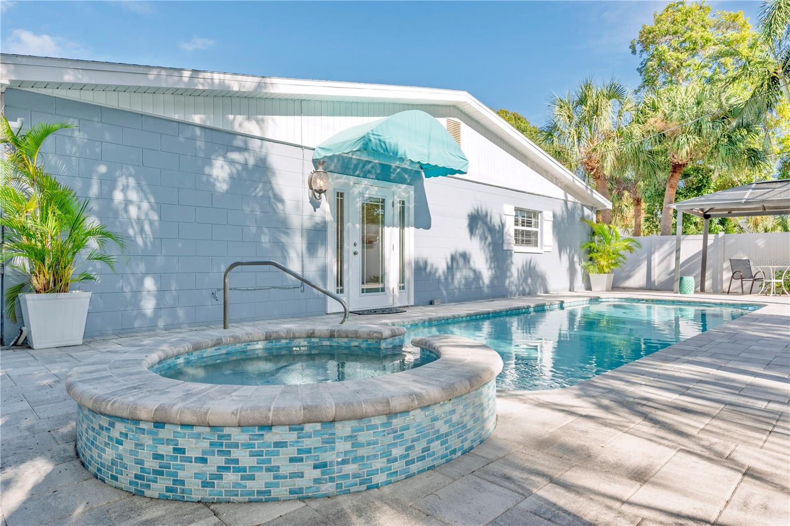 Heated saltwater pool with spillover spa.