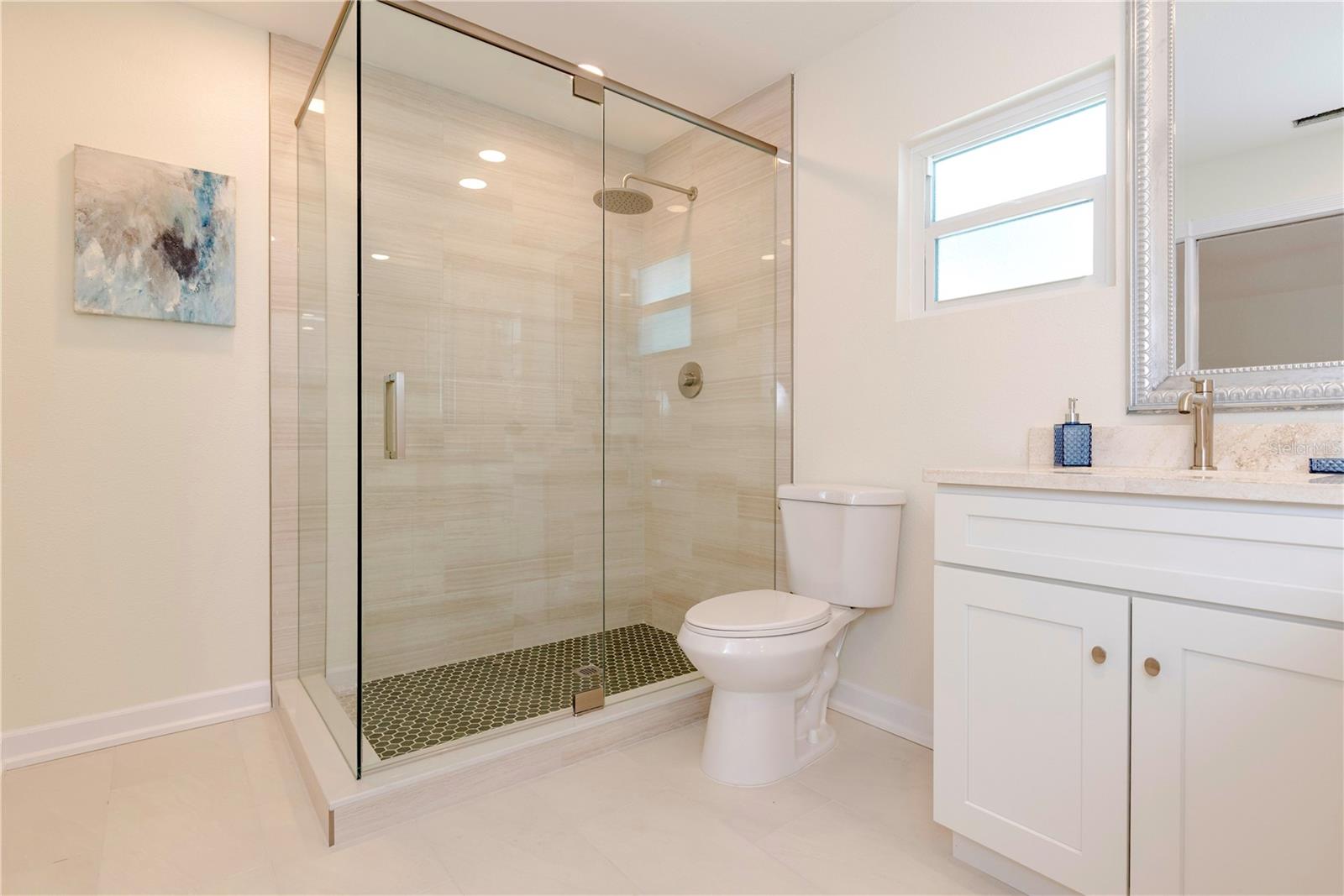 Primary bathroom with walk-in shower.