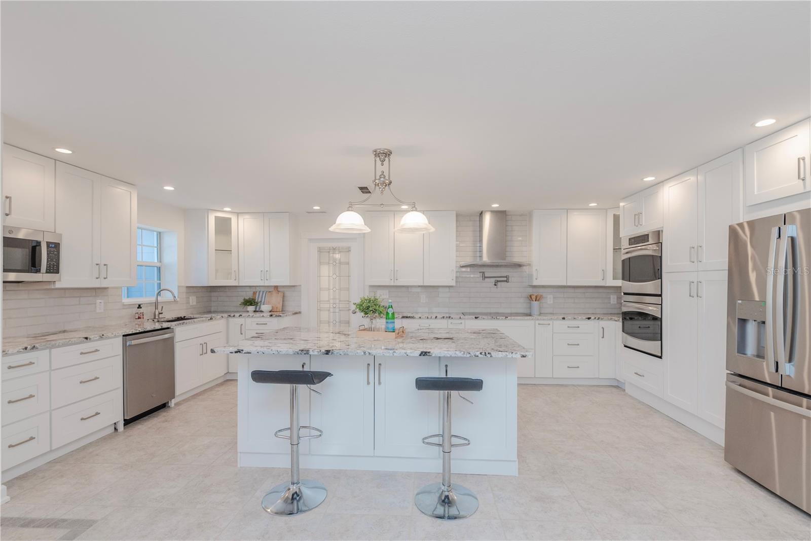 Gourmet kitchen with breakfast bar and island storage.