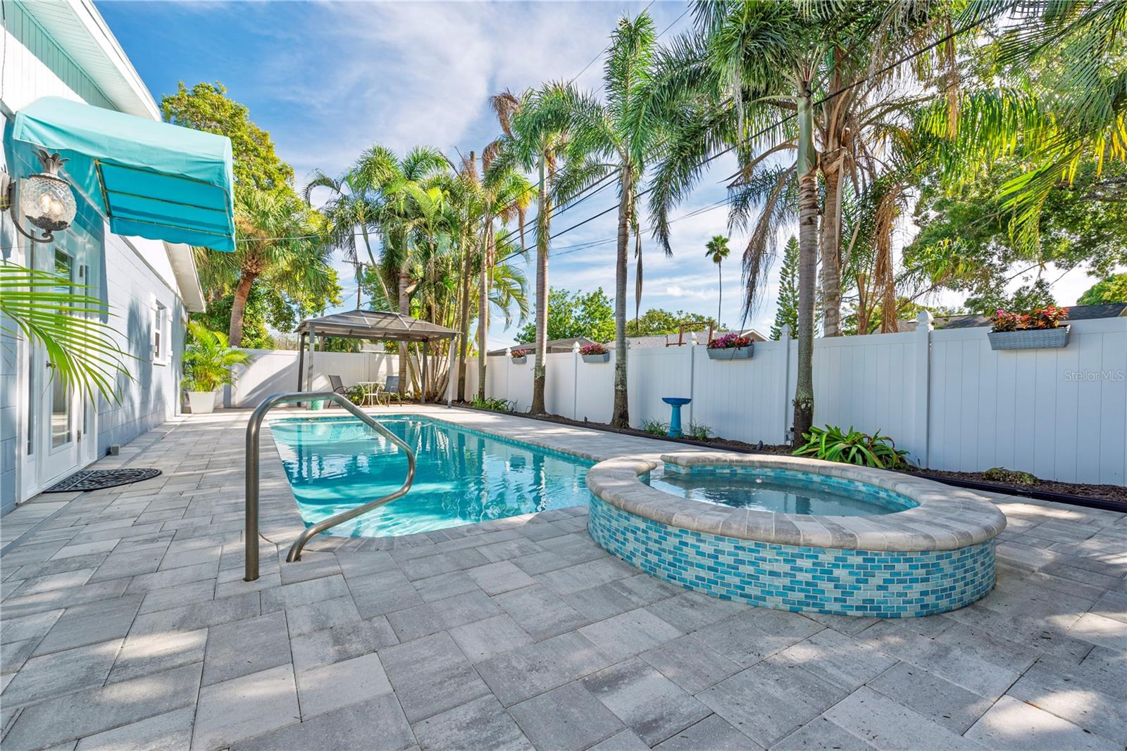 Spa and pool in the fenced back yard.