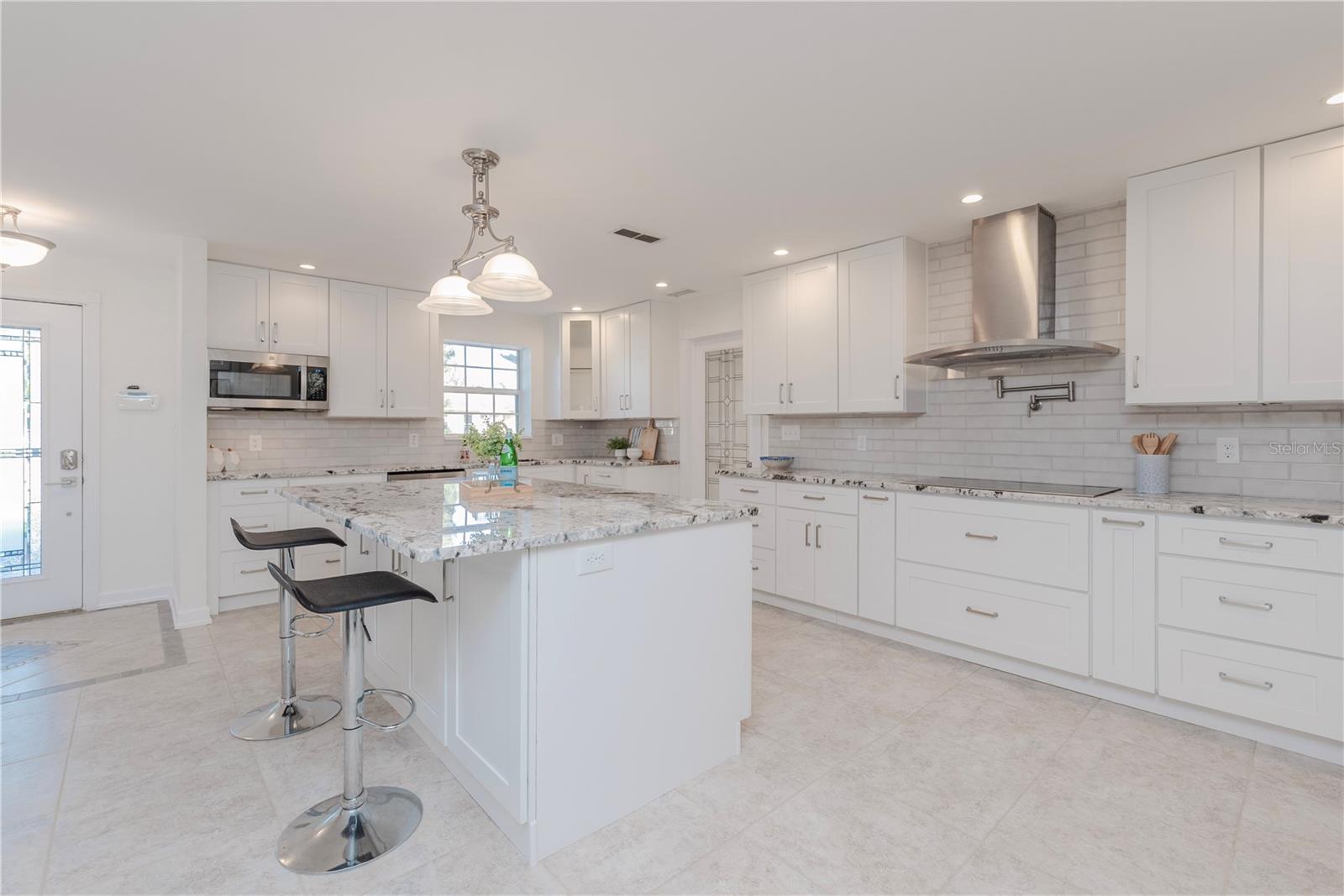 Hood vent, induction stove, pot filler, built-in microwave.