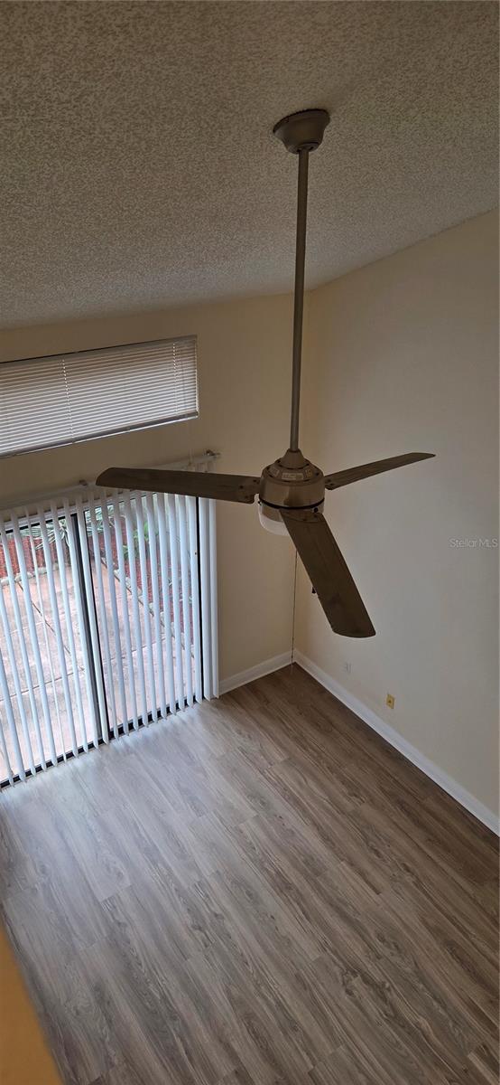 View from second level into living room with cathedral/vaulted ceiling