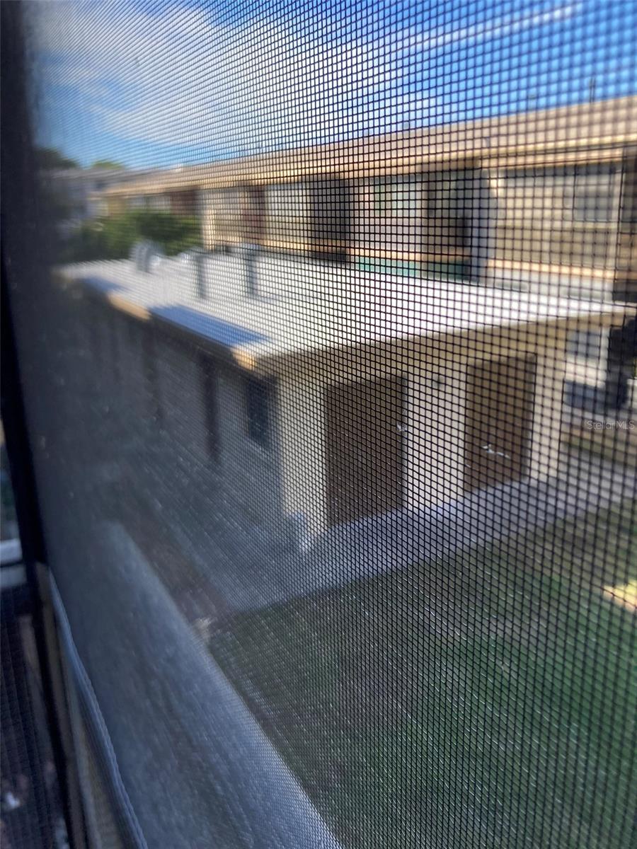 Balcony overlooks the community building that holds the laundry room.