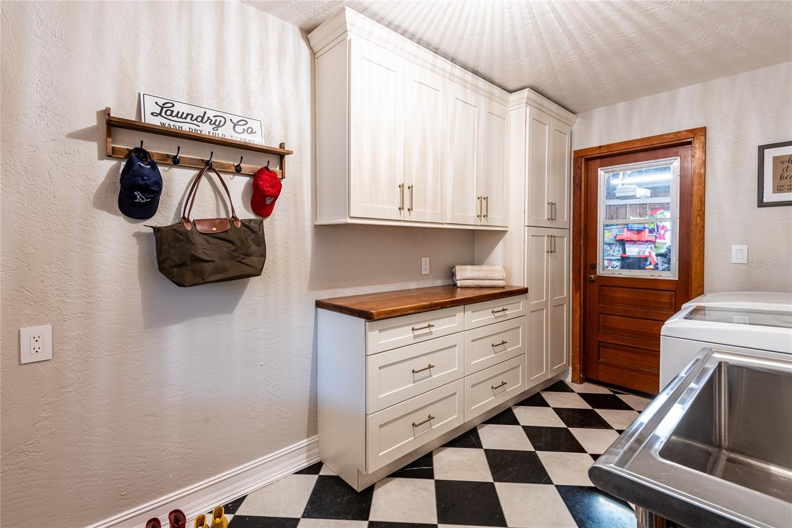 Mudroom/laundry room connects to the 2-car garage and workshop