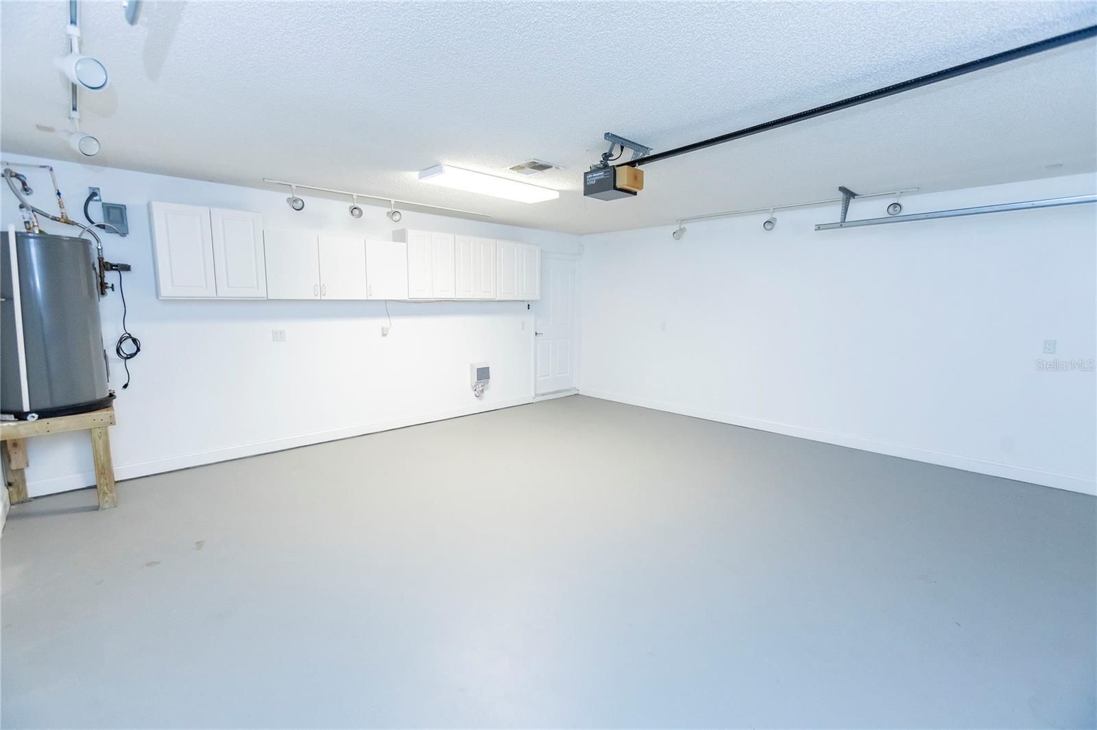 2 Car Garage climate controlled, finished floor, storage cabinets, extra lighting