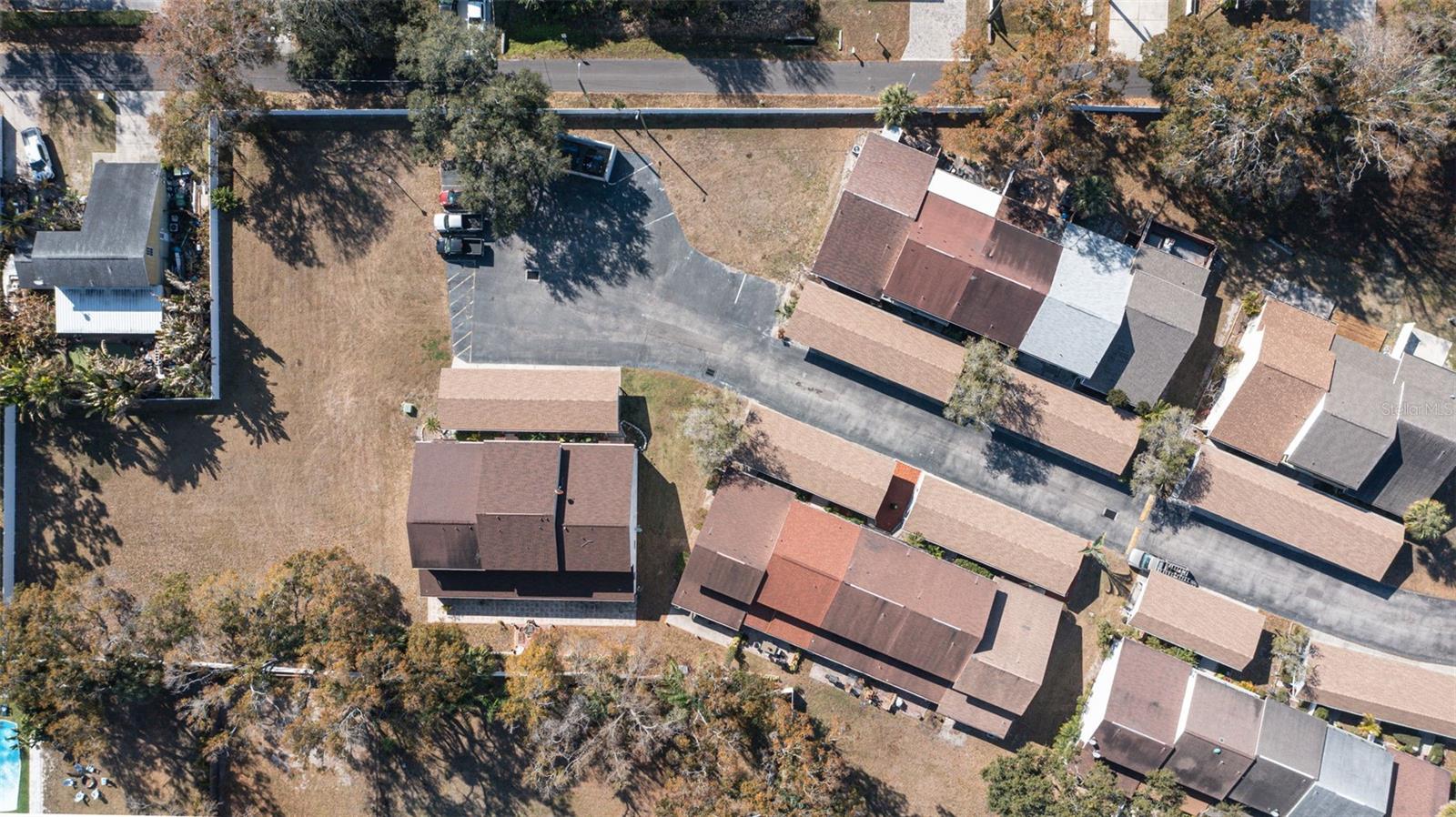 aerial view of community, cul-de-sac, guest parking, and open field