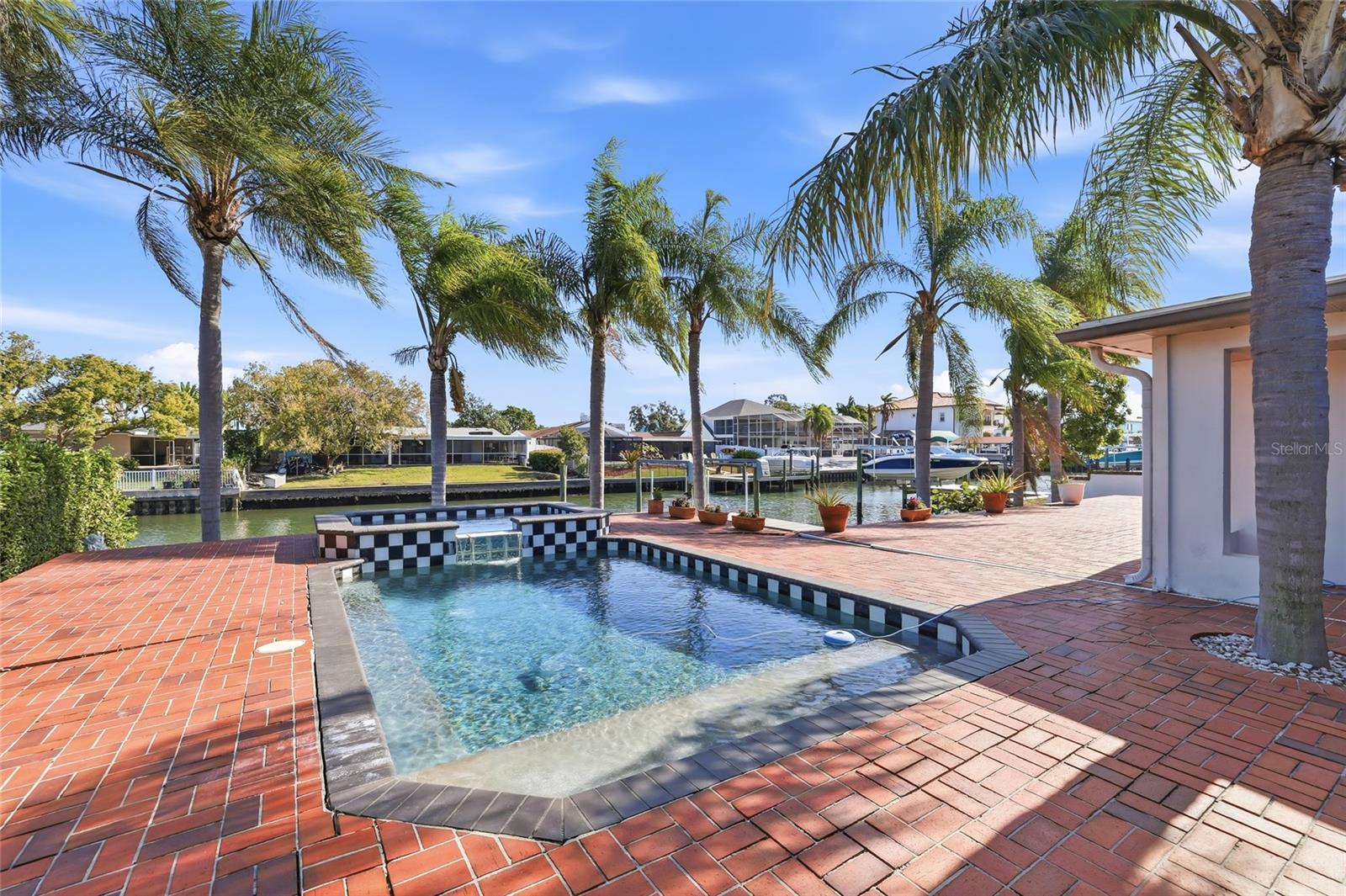 Back exterior pool deck and canal