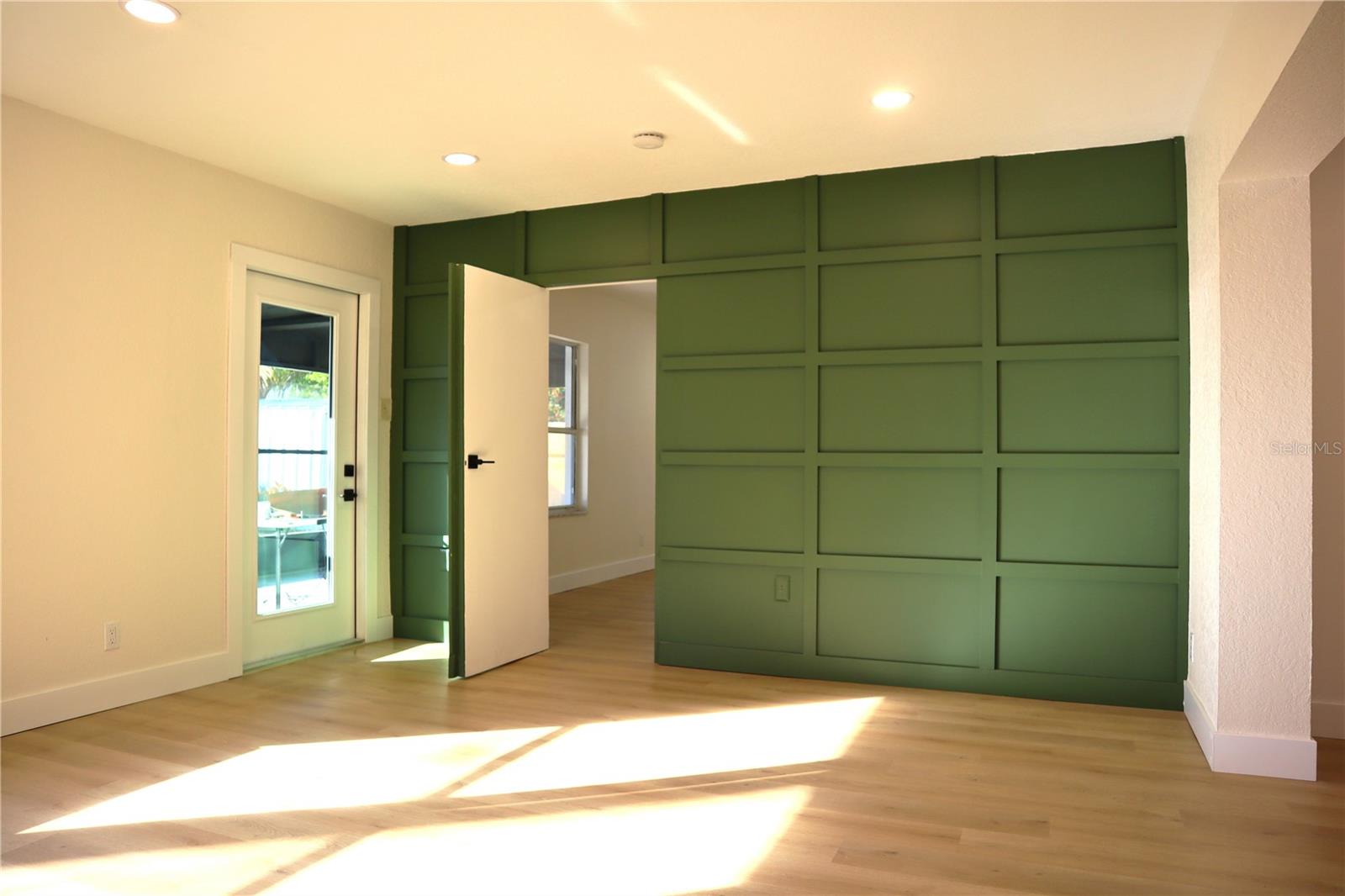 A hidden door to the third bedroom or office.
