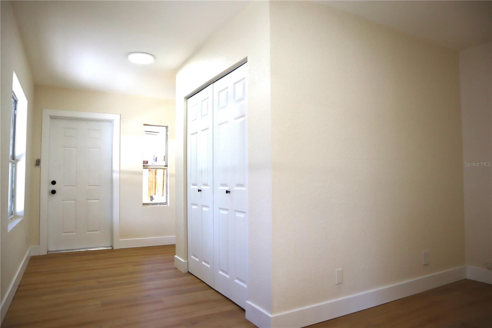 Walk through the hidden door and into a large L shaped bedroom or office, with an exterior door to the back yard.