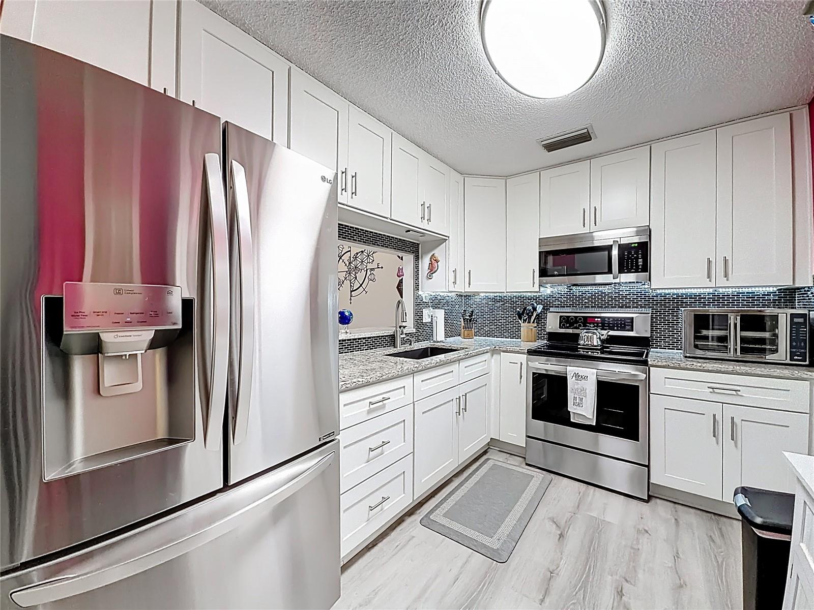 502 Bough Ave - kitchen with white cabinets and granite counters