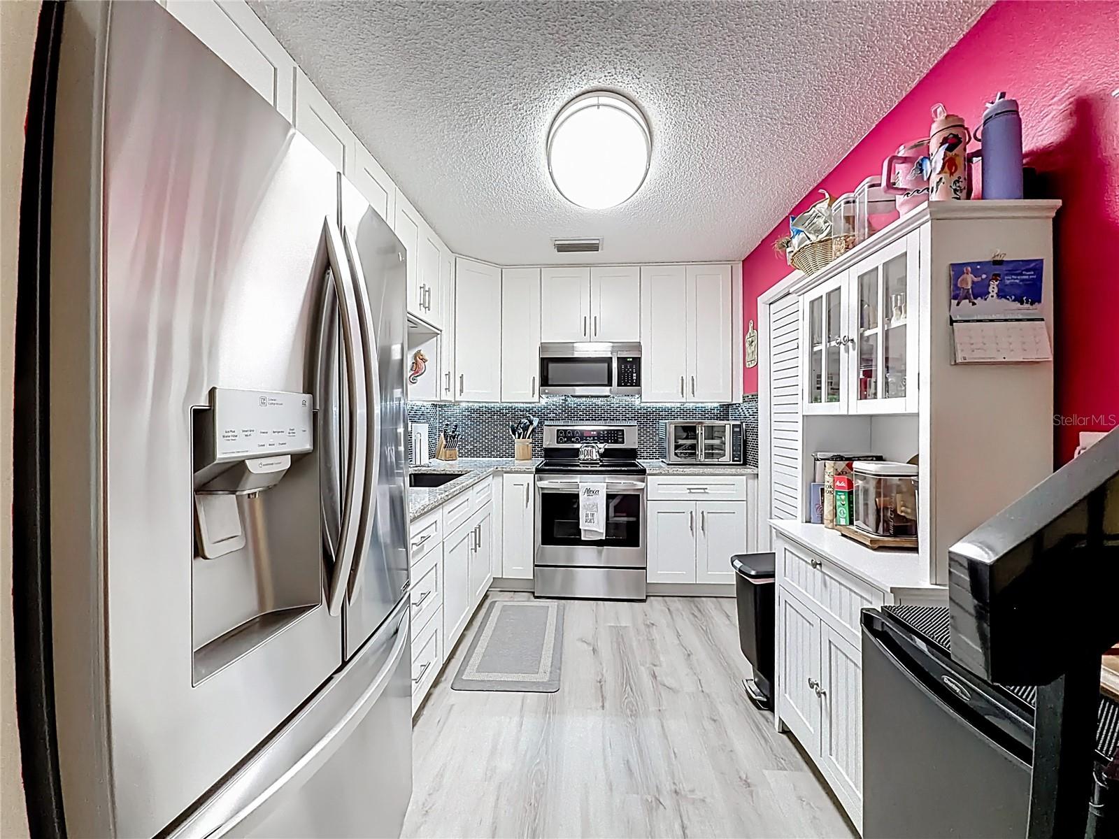 502 Bough Ave - kitchen with white cabinets and granite counters