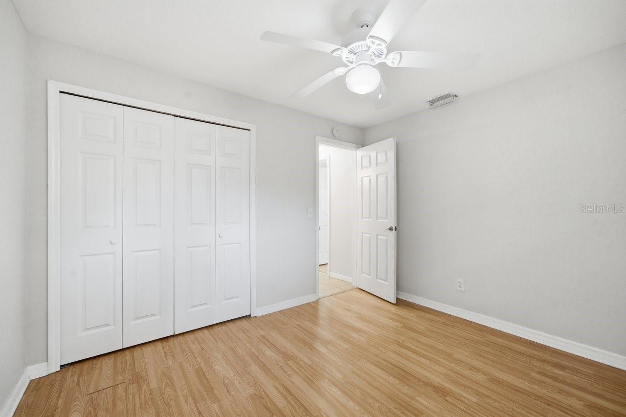 Primary Bedroom with built in closet and laminate floor.